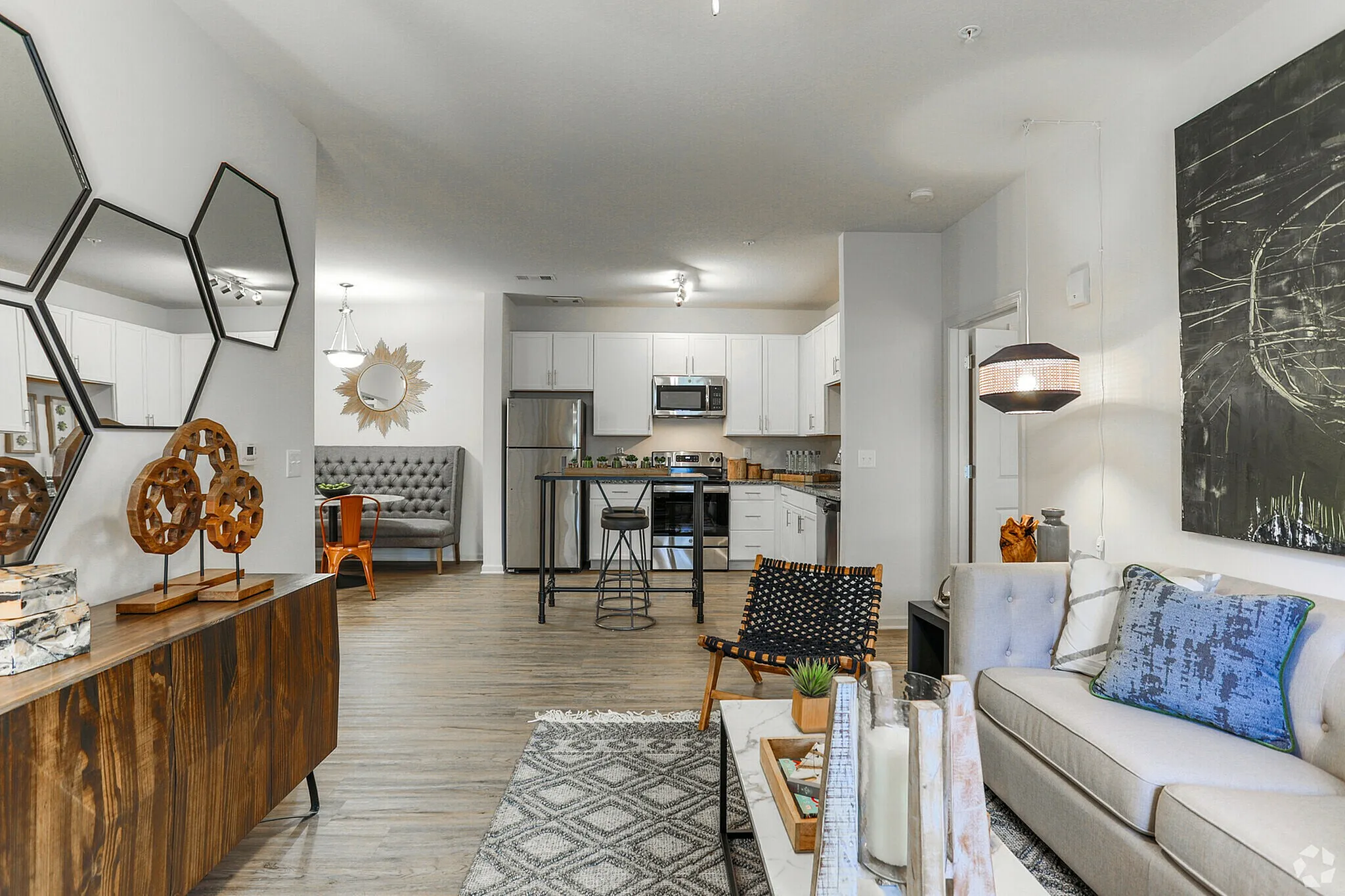 Modern open-plan living space with chic decor, featuring a stylish kitchen, cozy seating area, and elegant furnishings.