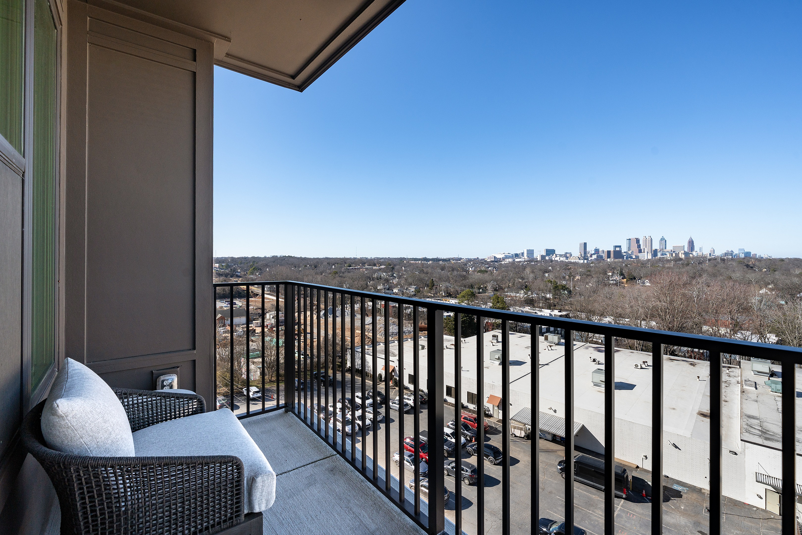 Chic apartment balcony offering stunning city skyline views, perfect for relaxation and enjoying urban living.