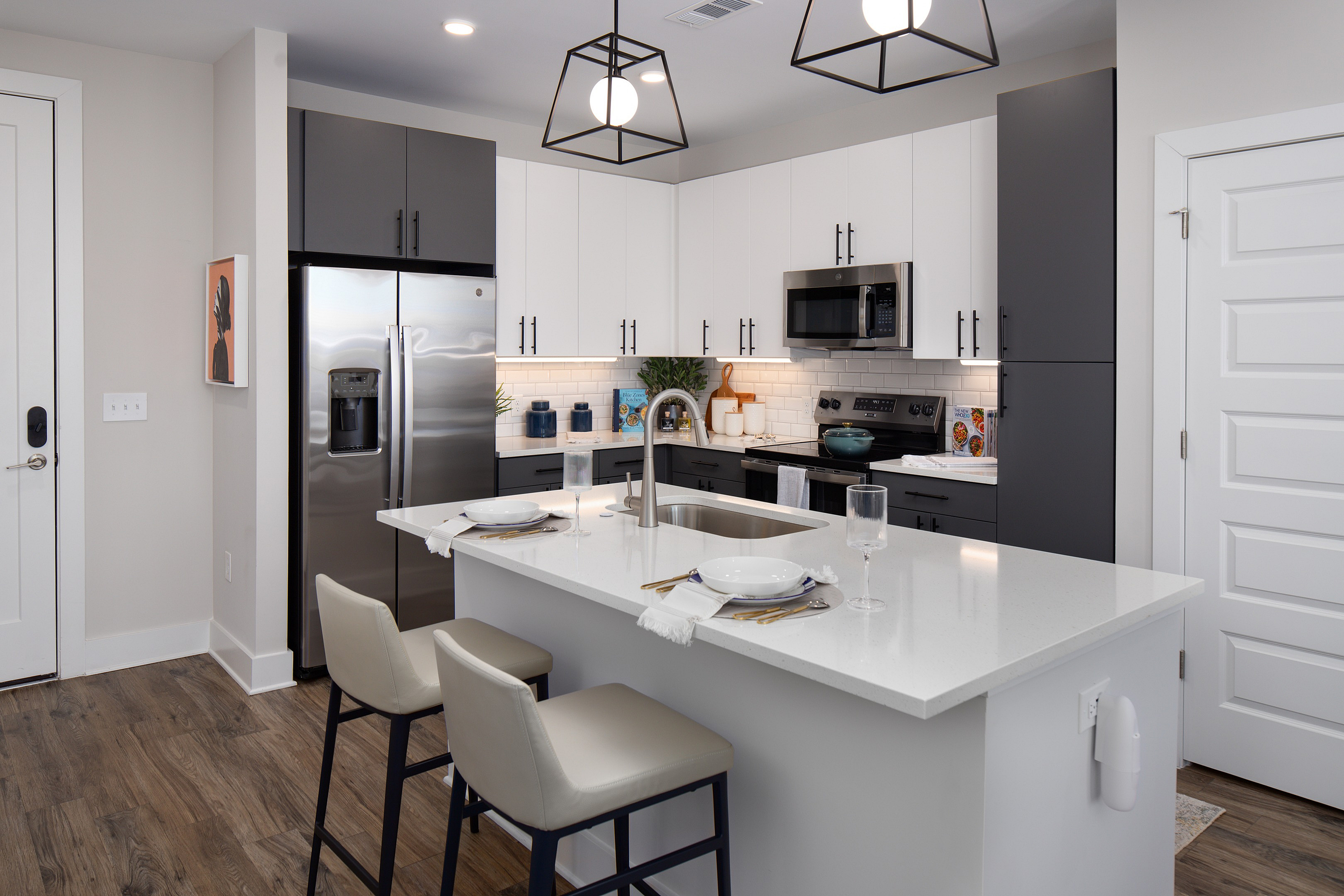 Sleek modern kitchen featuring a center island with elegant bar seating, stainless steel appliances, and minimalist cabinetry.