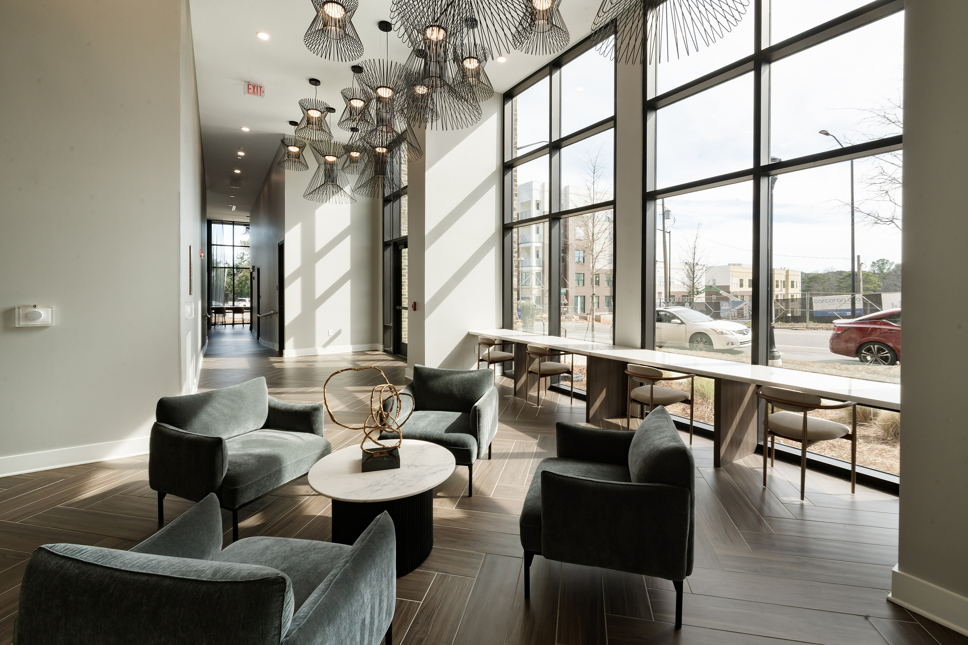 Bright, modern lobby with plush seating, elegant decor, and floor-to-ceiling windows offering abundant natural light.
