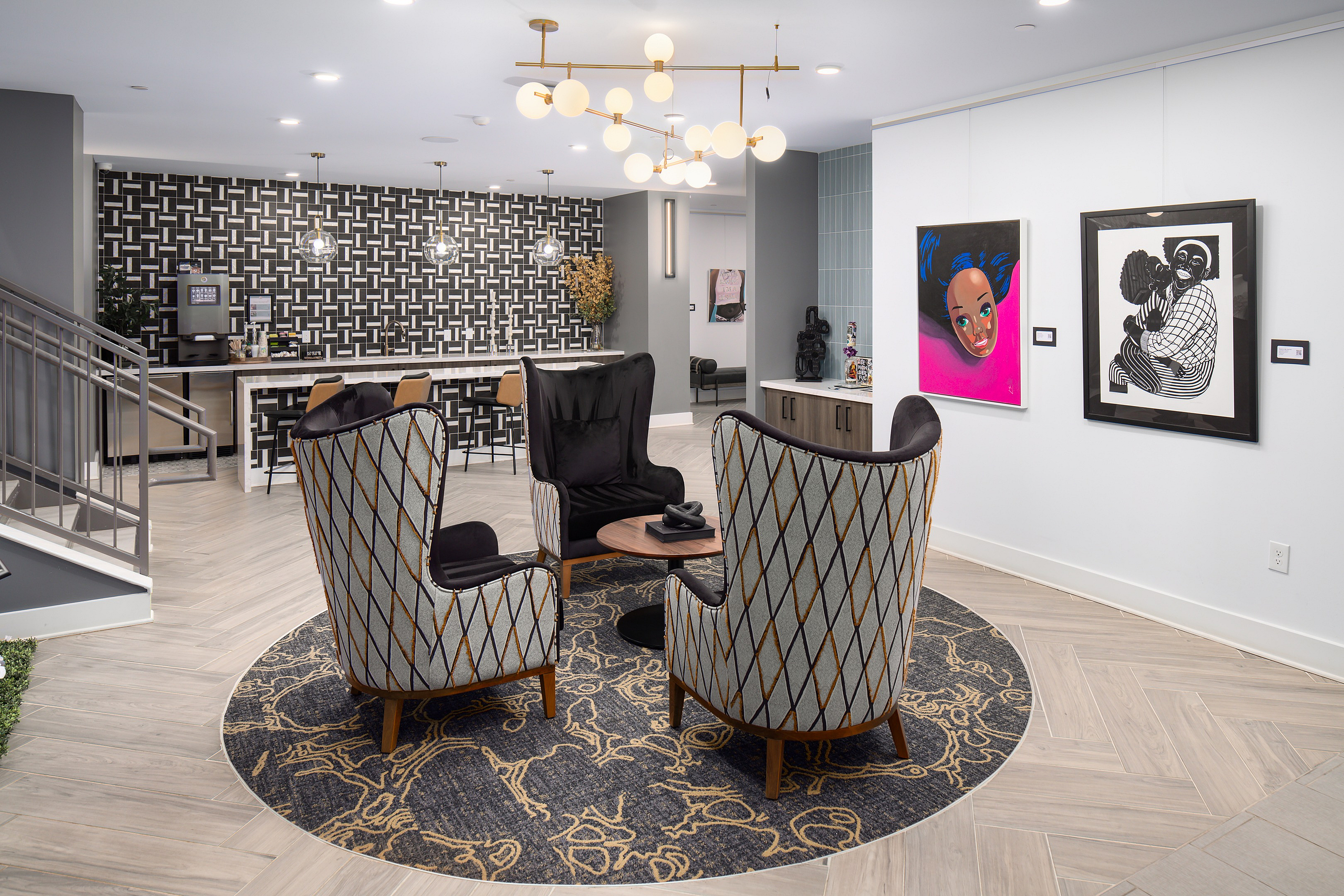 Contemporary lounge featuring elegant patterned chairs, stylish lighting, and modern art on display.