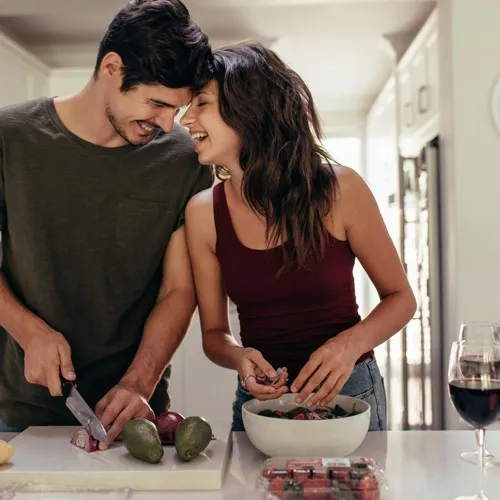 couple in kitchen cooking