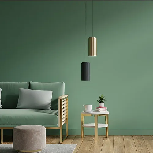 Stylish living room with a green sofa, modern pendant lights, and elegant house plants.