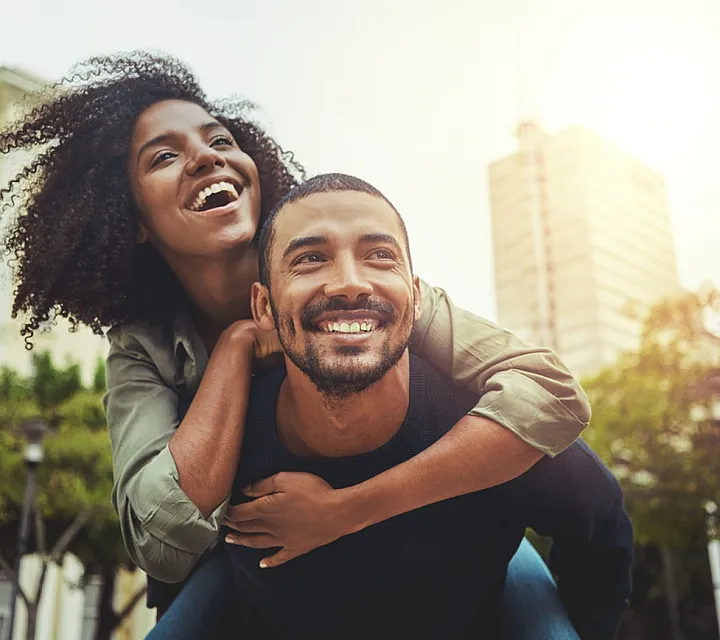 Cheerful couple enjoying a sunny day in the city.