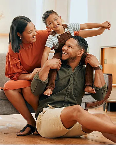 Happy family enjoying a moment together in a bright, modern living room.