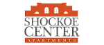 Logo of Shockoe Center Apartments featuring a stylized building silhouette in orange.