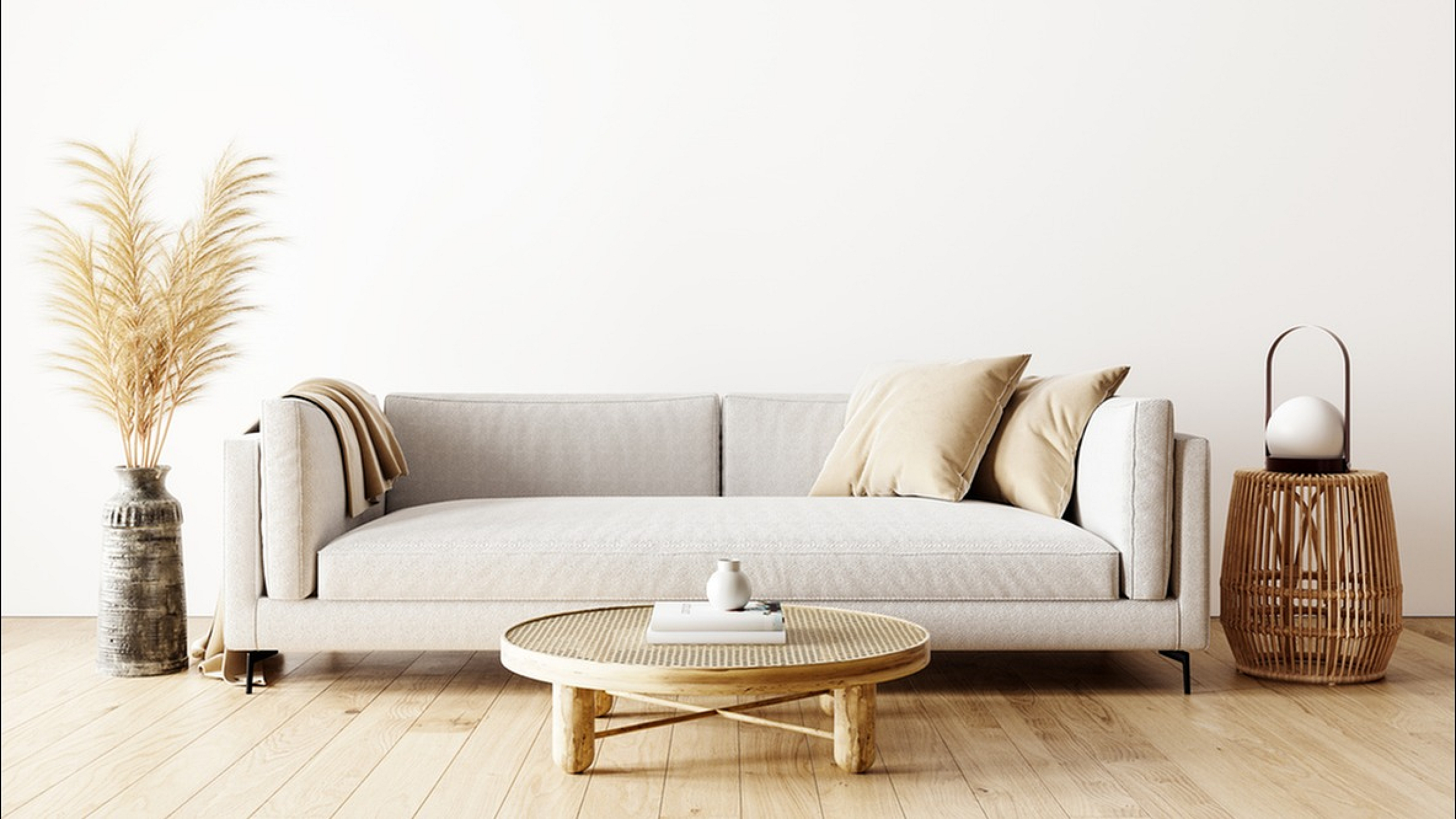 Elegant minimalist living room with a modern beige sofa, wicker coffee table, and chic decor.