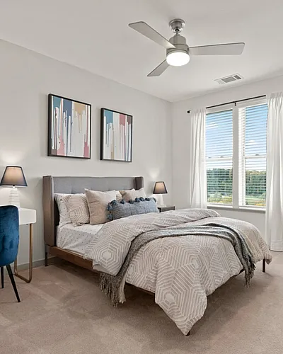 Elegant bedroom with modern decor, featuring a cozy bed, stylish wall art, and a contemporary study nook.