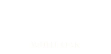 Elegant logo for White Oak Luxury Apartments featuring a stylized oak tree.