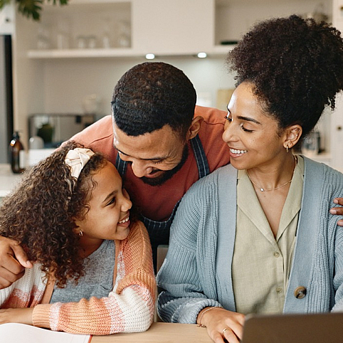Happy family enjoying time together in a modern kitchen with natural light.