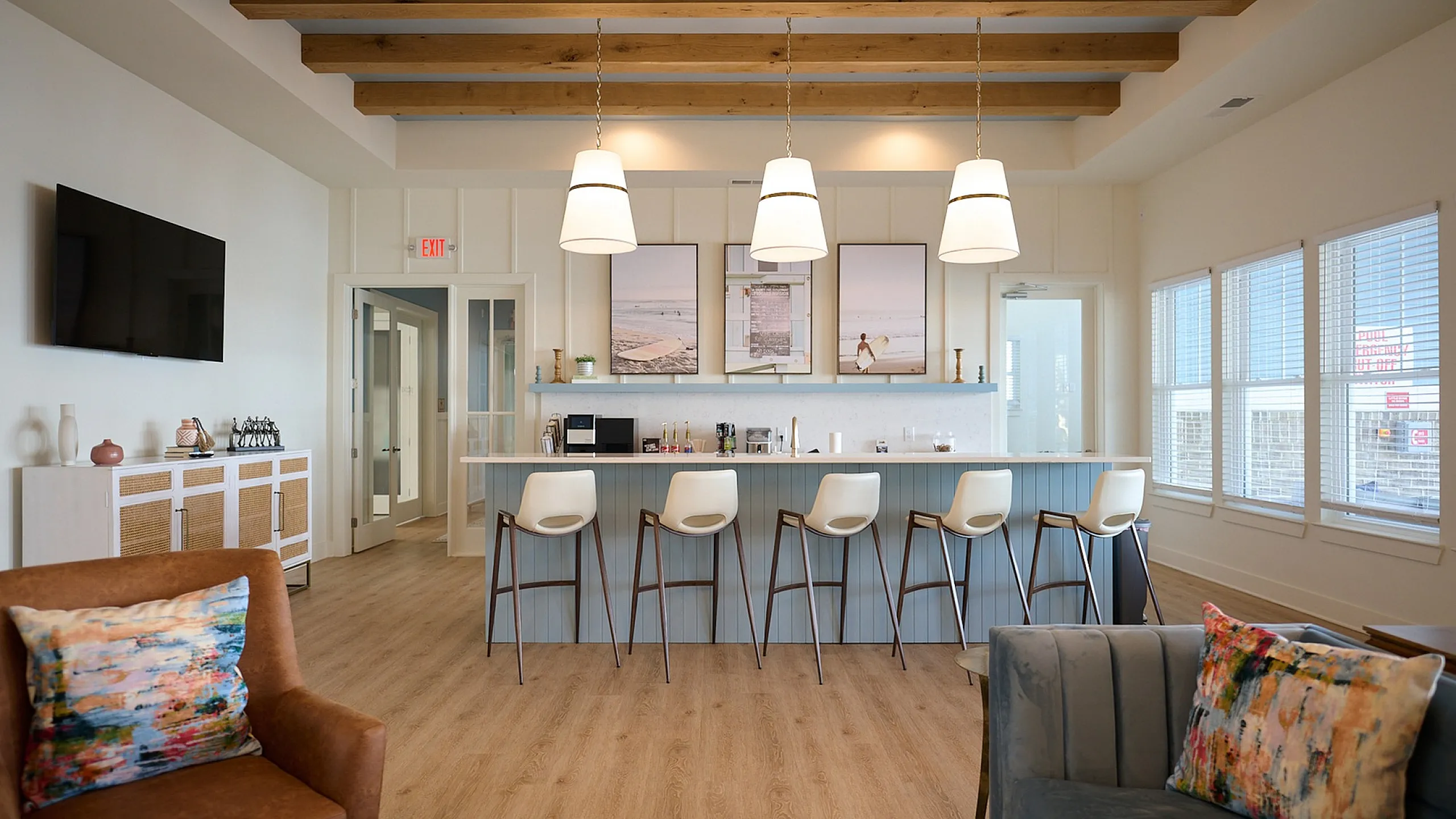 Chic kitchen with bar seating, pendant lighting, and tasteful decor.