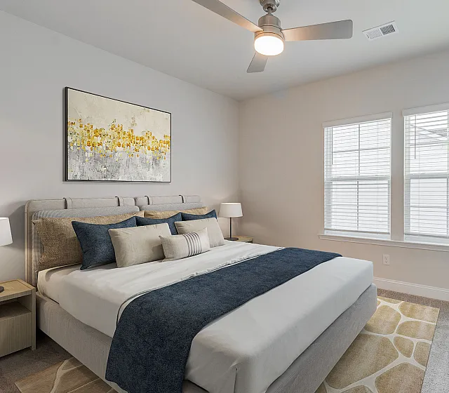 Bright and inviting bedroom with contemporary decor, featuring a plush bed, modern artwork, and large windows for abundant natural light.