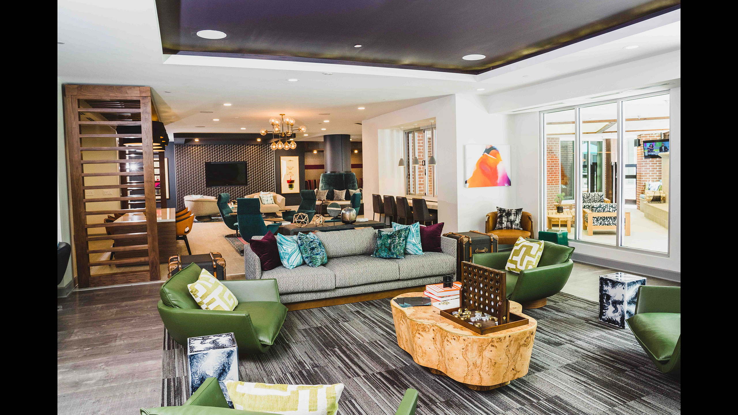 Luxurious open-concept living room with modern decor, vibrant seating, and elegant lighting, perfect for stylish entertaining.