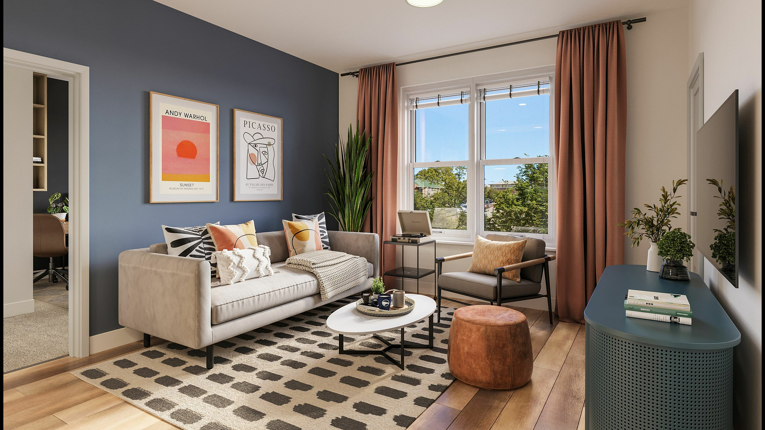 Elegant living room with modern decor, featuring a cozy beige sofa, vibrant pillows, stylish wall art, and a large window with scenic views.