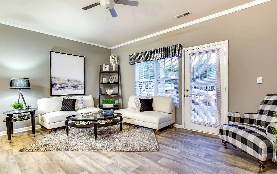 Elegant living room featuring a plush white sectional sofa, chic coffee table, and stylish decor with a light-filled atmosphere.
