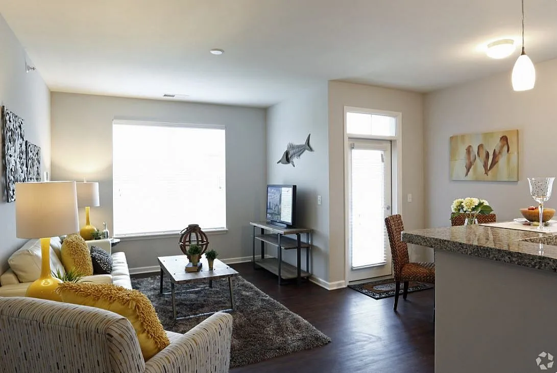 Bright and inviting living room with modern decor, plush seating, and open layout. Features natural light, hardwood floors, and stylish accents for a cozy atmosphere.