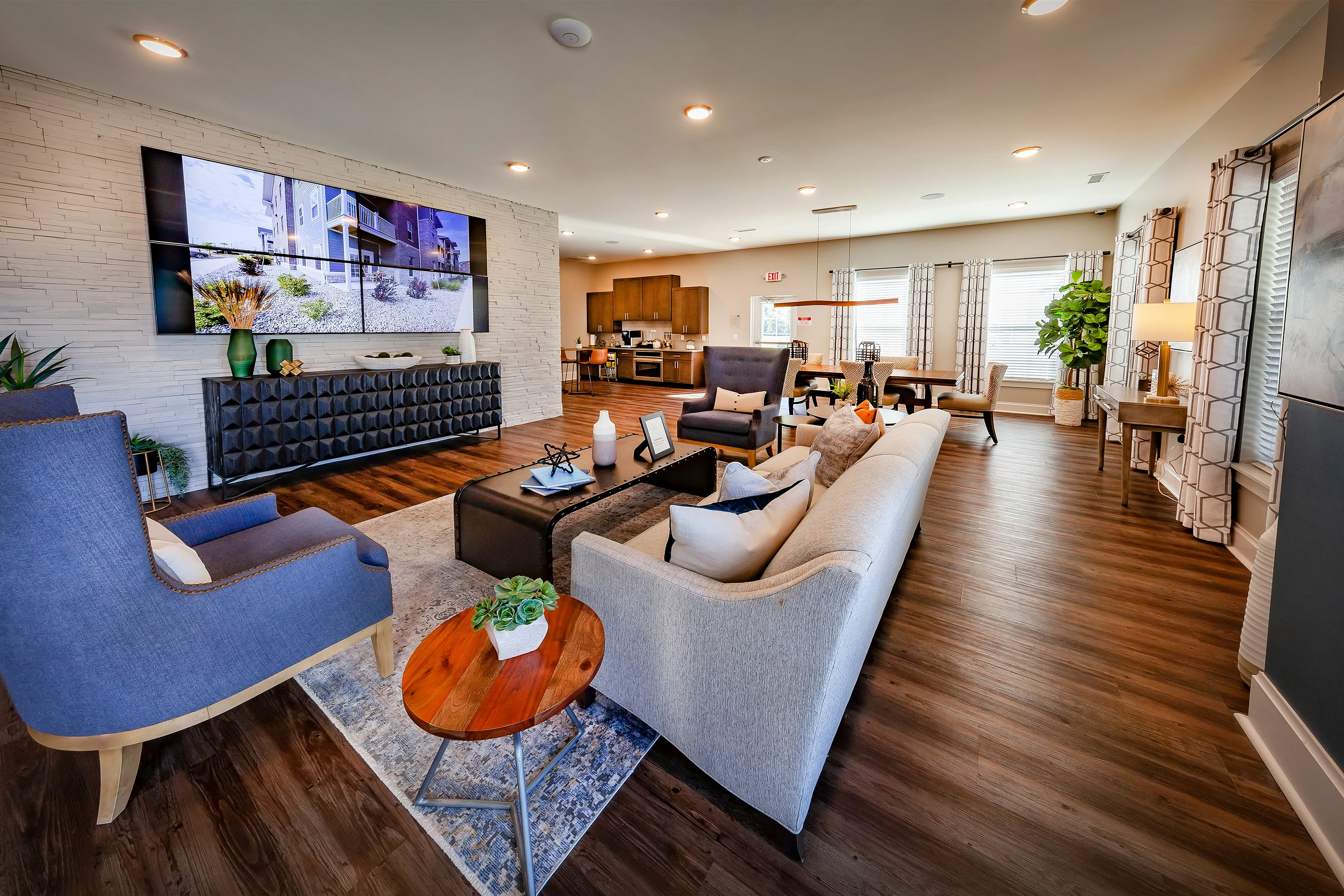 Luxurious open-concept living area featuring elegant furniture, hardwood floors, and a cozy ambiance perfect for relaxation and entertainment.