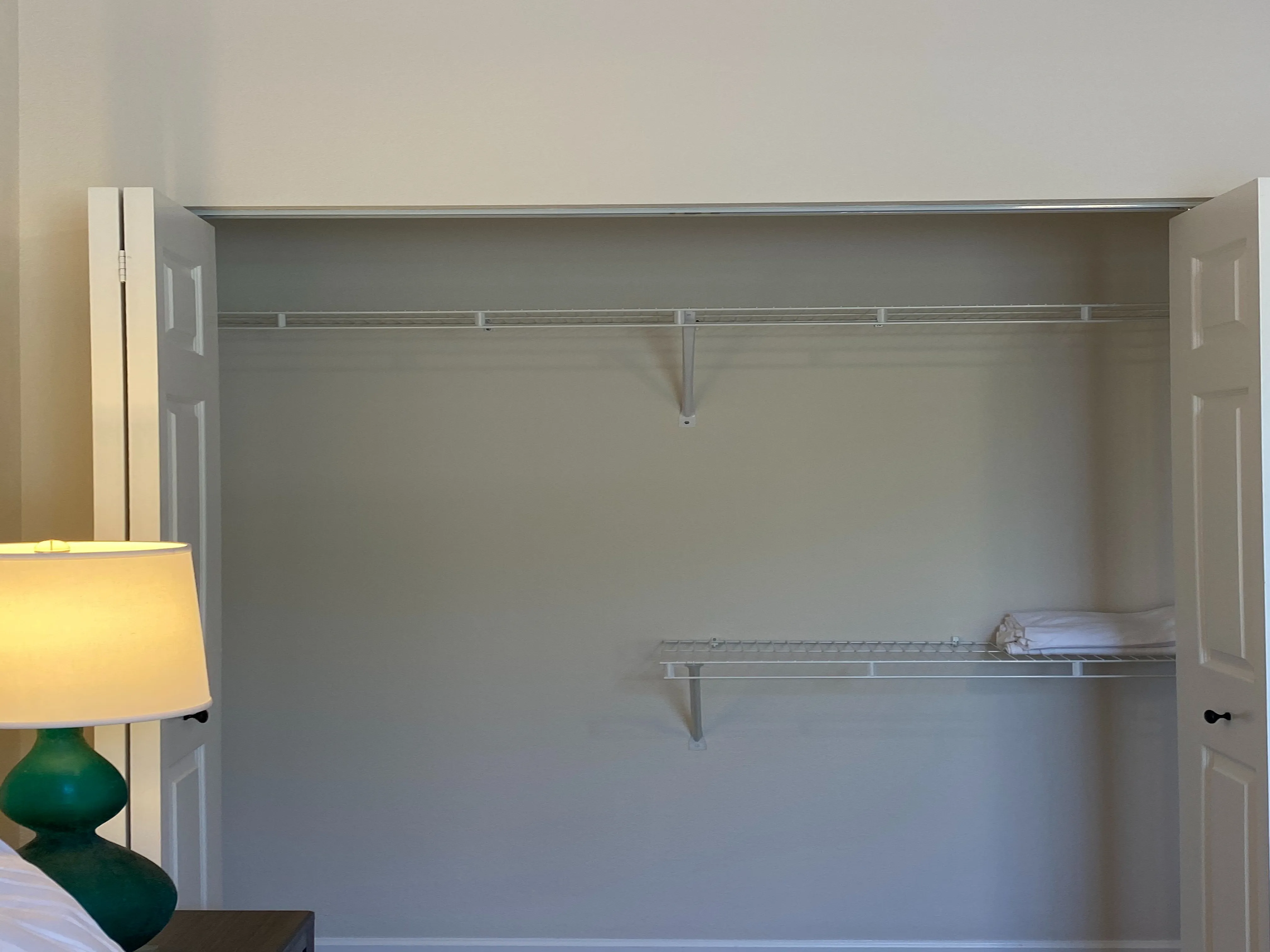 Spacious and elegant walk-in closet with ample shelving, perfect for organized living.