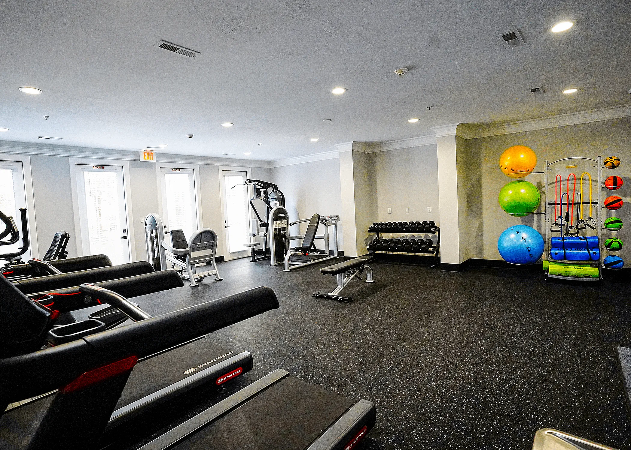 Modern fitness center with state-of-the-art cardio machines, free weights, and vibrant workout gear, promoting a healthy lifestyle.