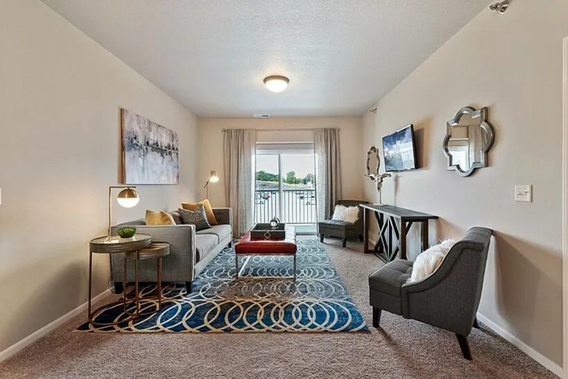 Inviting living room featuring modern decor, plush seating, and a large window with a scenic view.