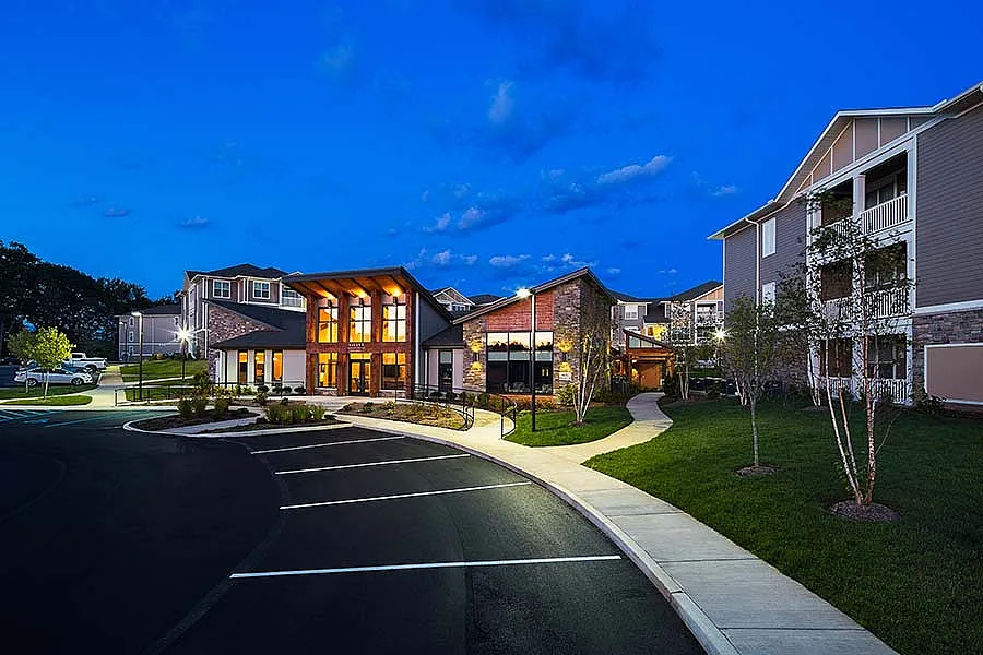 Beautiful apartment complex at twilight with modern architecture and well-lit pathways.