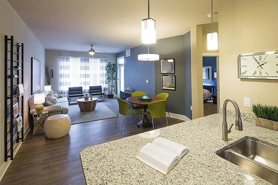 Modern open-concept living space with stylish decor, granite countertops, and cozy seating area.