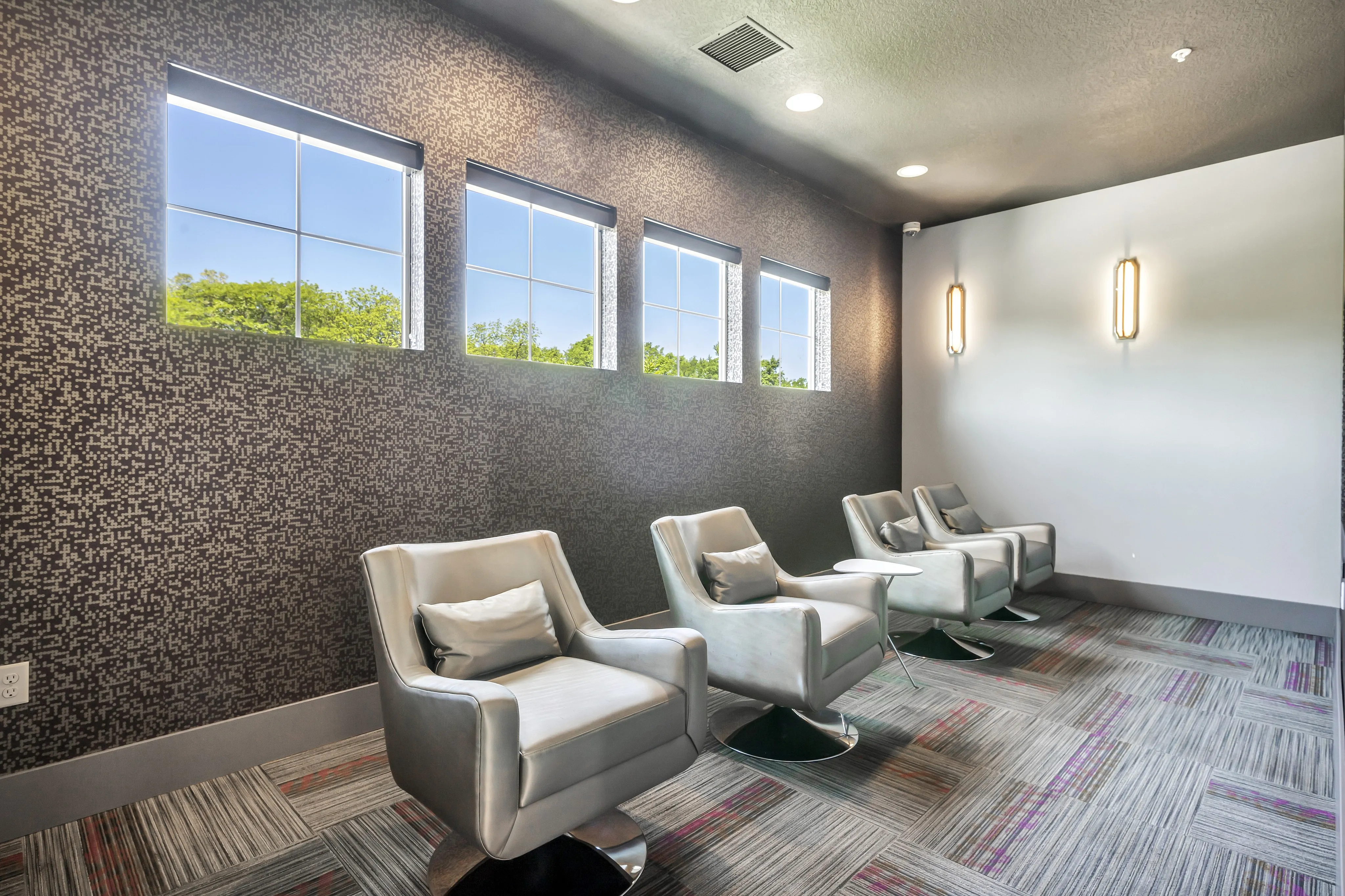 Modern lounge area with sleek seating, contemporary lighting, and large scenic windows.