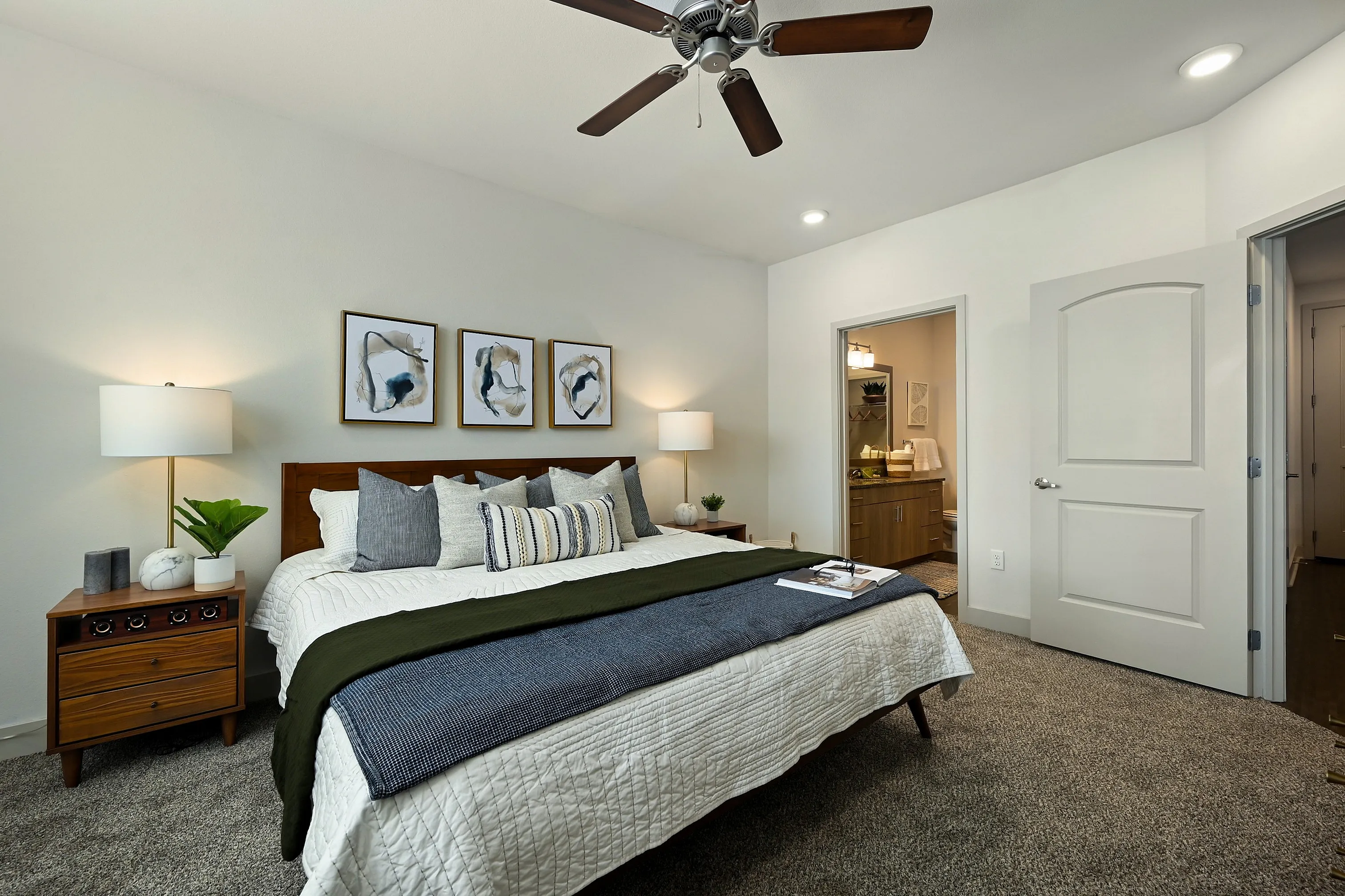 Inviting bedroom with modern decor, featuring a king-size bed, stylish artwork, and warm lighting for a cozy, elegant ambiance.