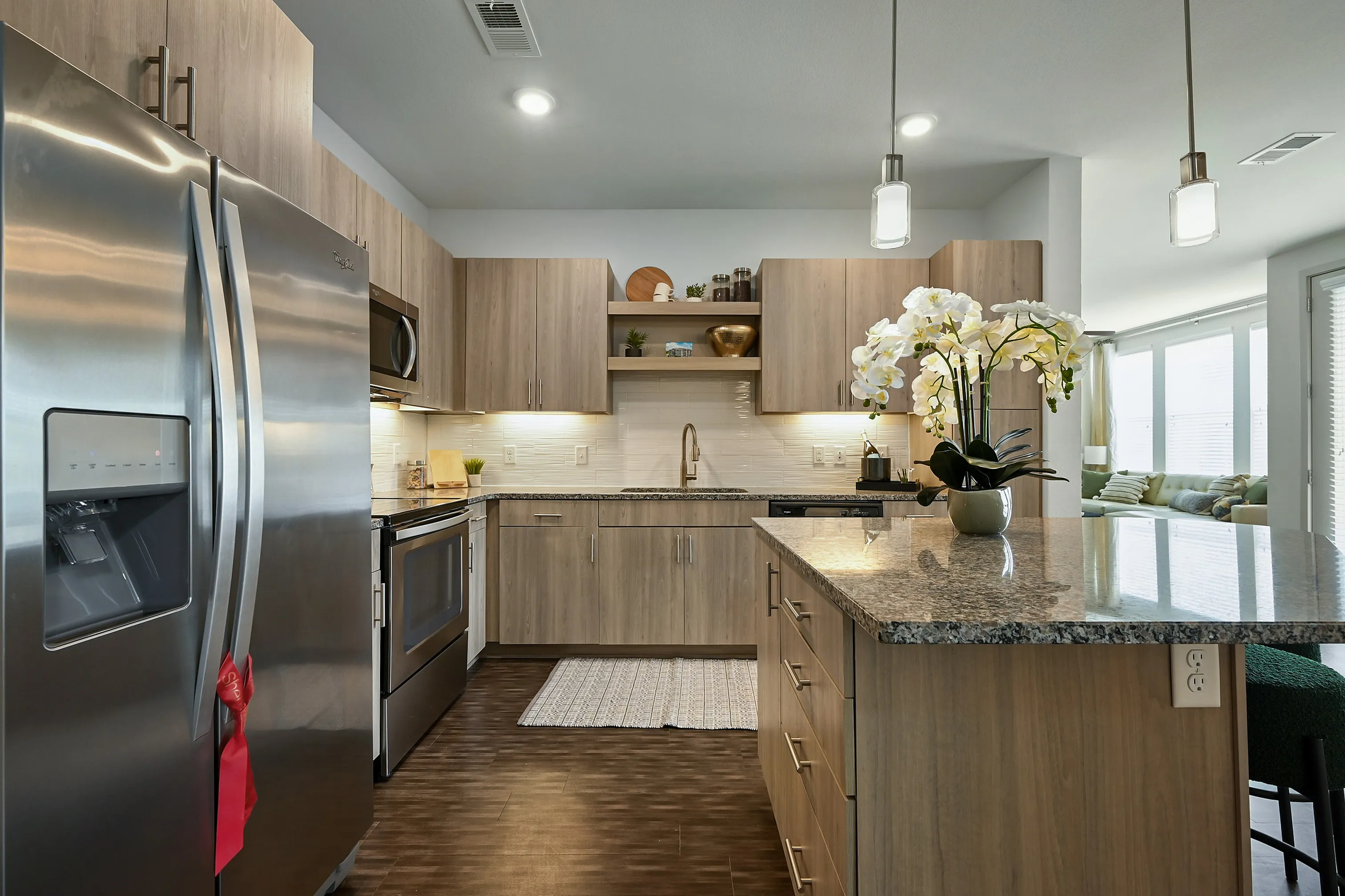 Modern kitchen with sleek stainless steel appliances, elegant granite countertops, and inviting open-concept layout.