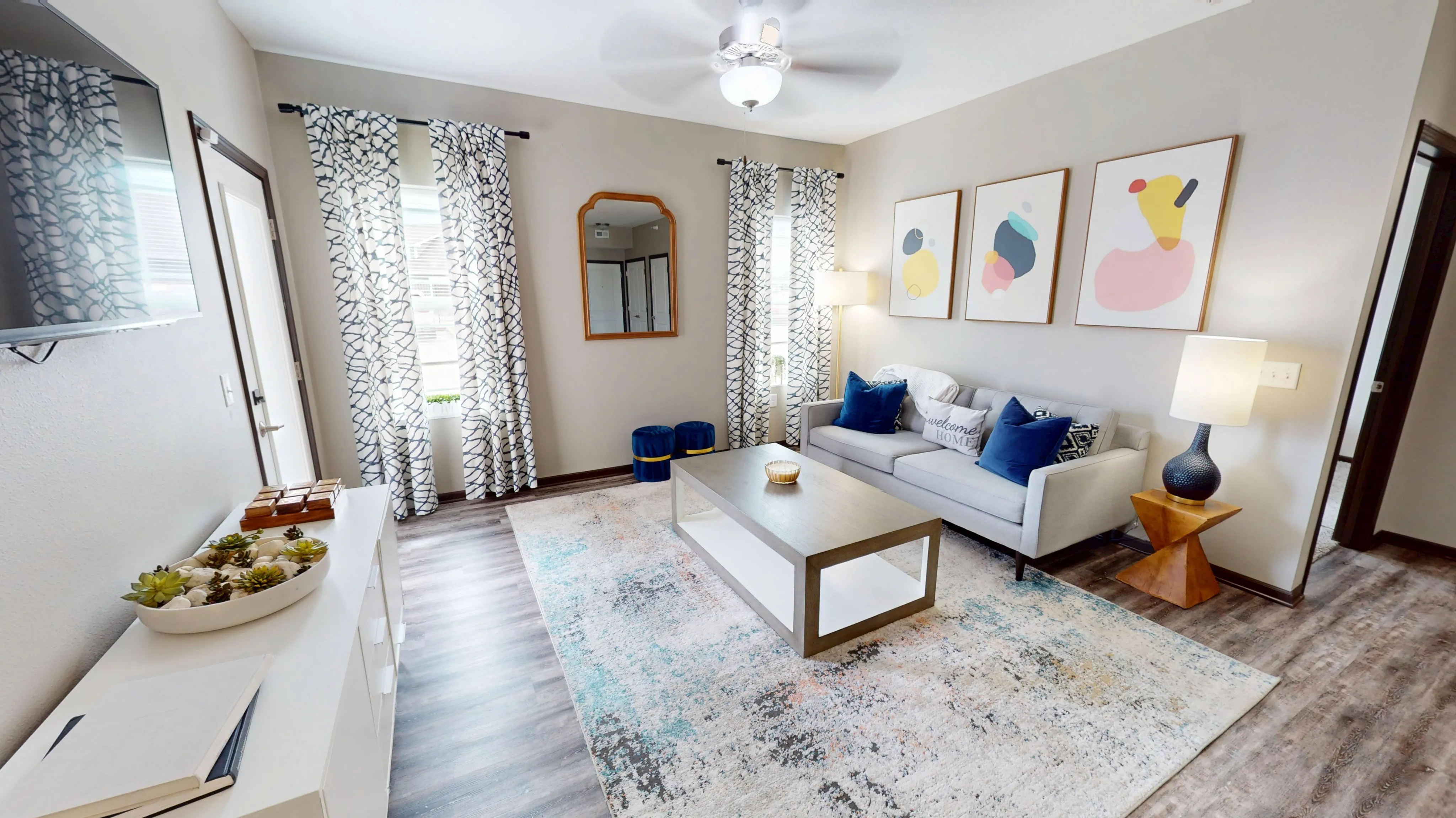 Chic living room with modern decor, abstract artwork, and natural light creating a welcoming atmosphere.