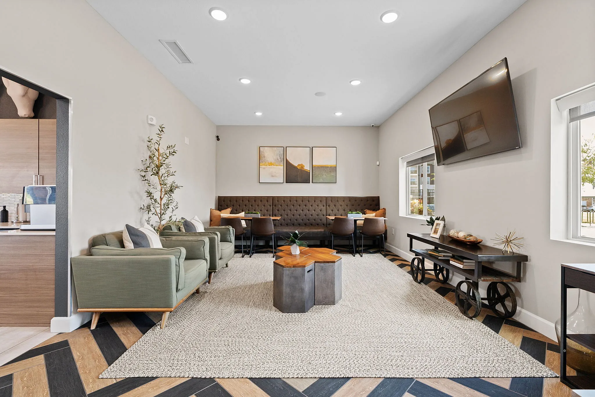 Elegant living space with stylish seating, modern decor, and a large wall-mounted TV perfect for relaxation.