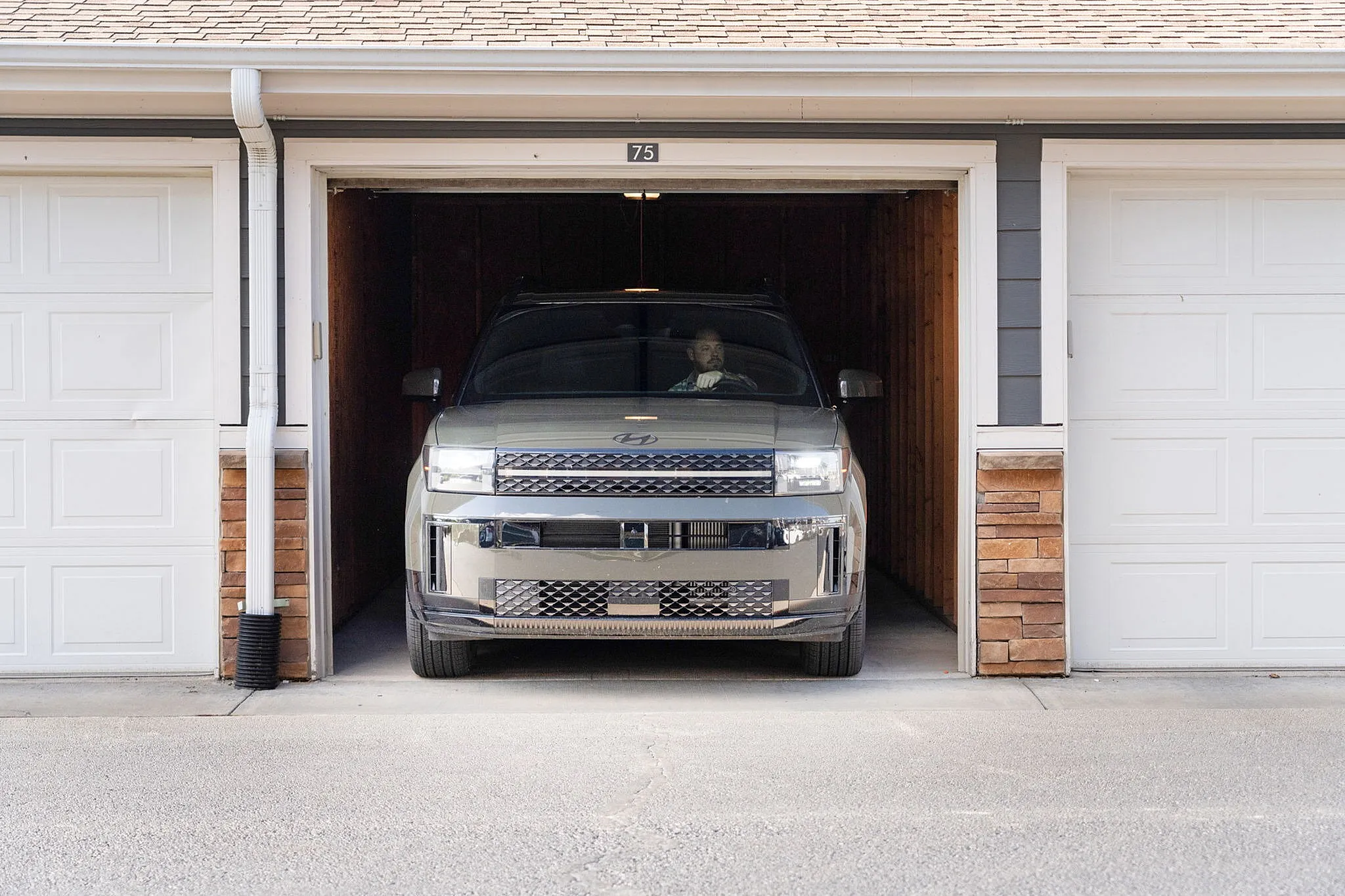Modern car parked in a stylish garage showcasing sleek residential architecture.