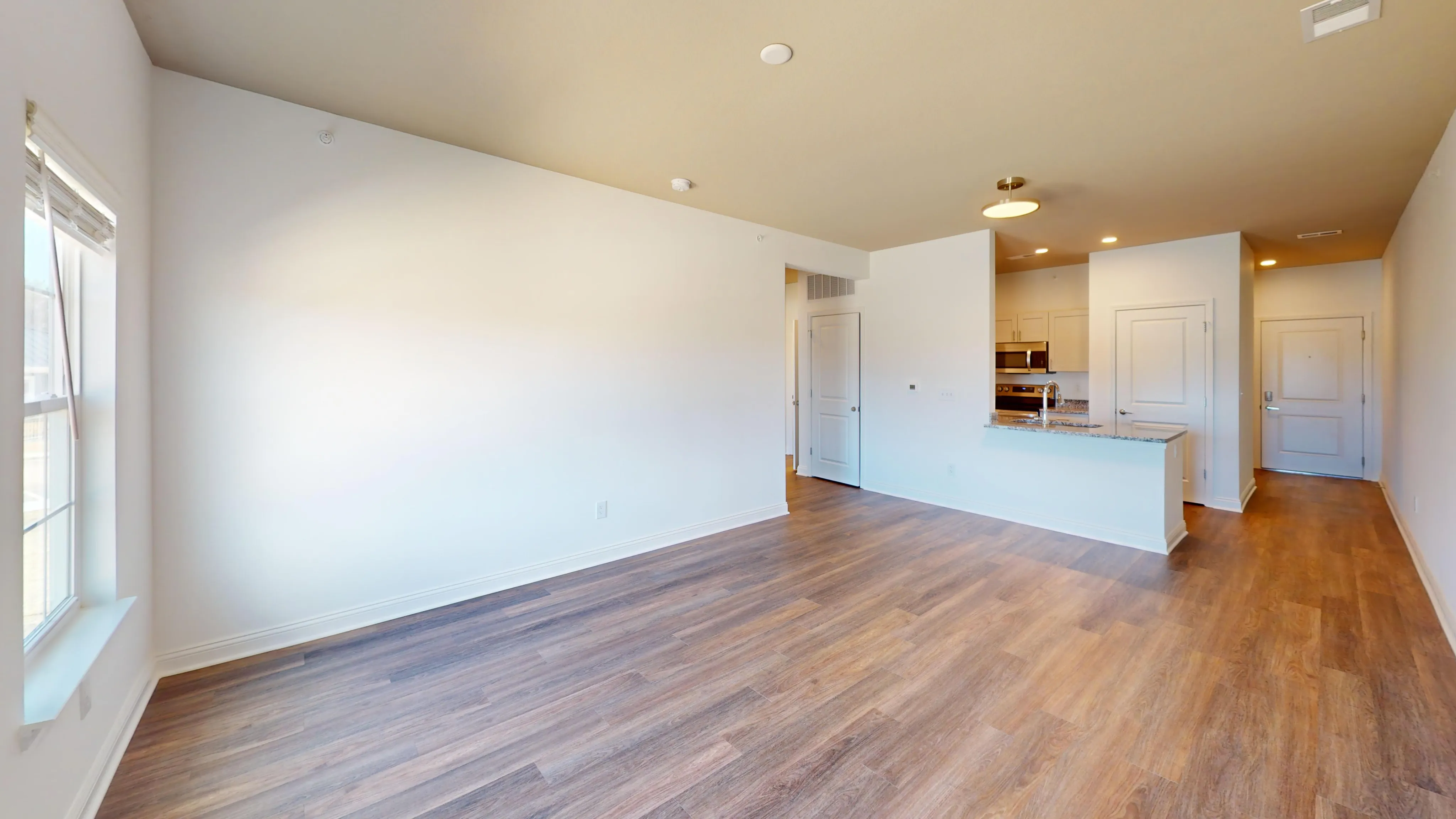 Chic floor plan highlighting a spacious living room into a modern kitchen.