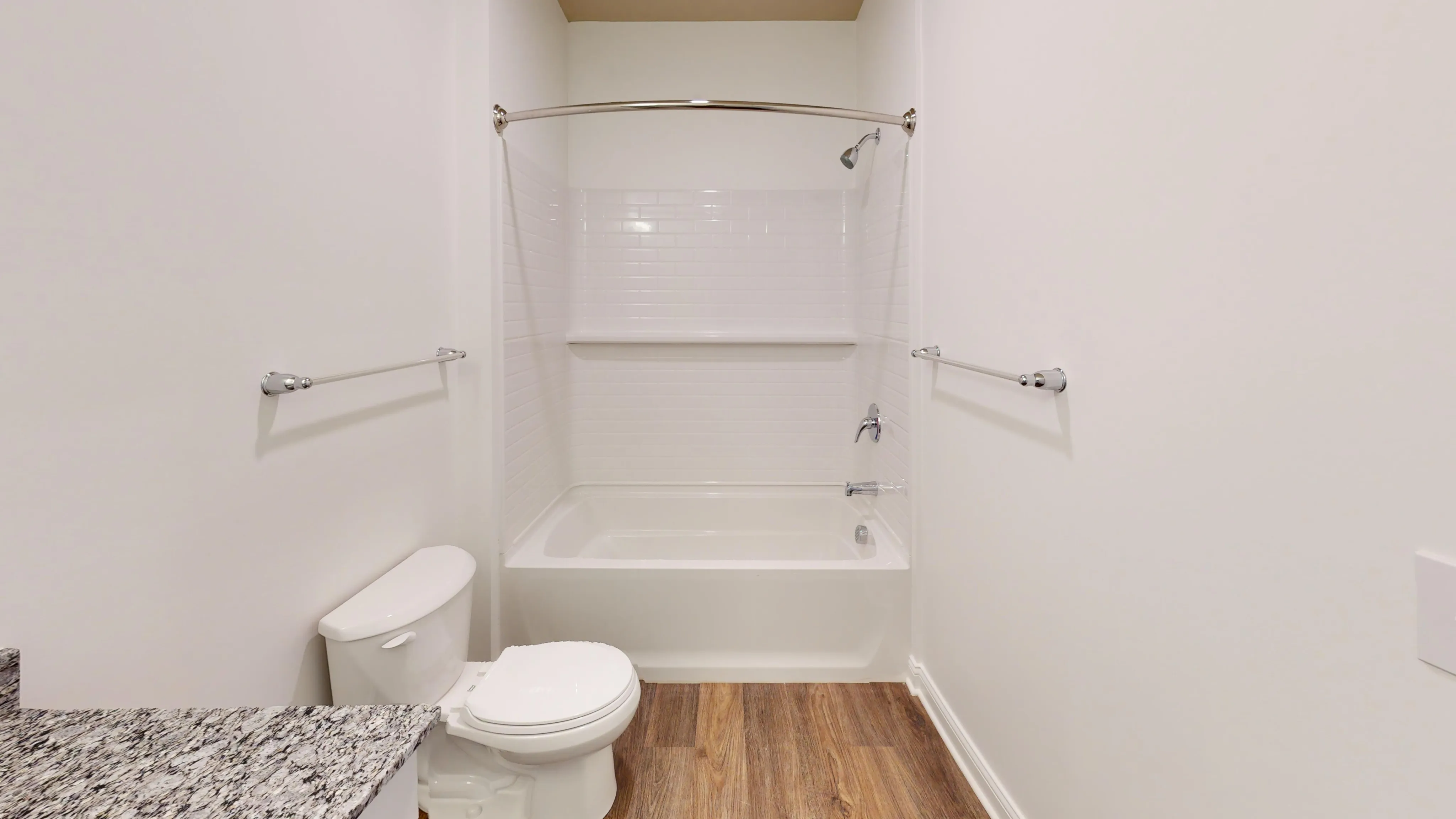 Bright, large bathroom with a marble sink and shower/bathtub combo.