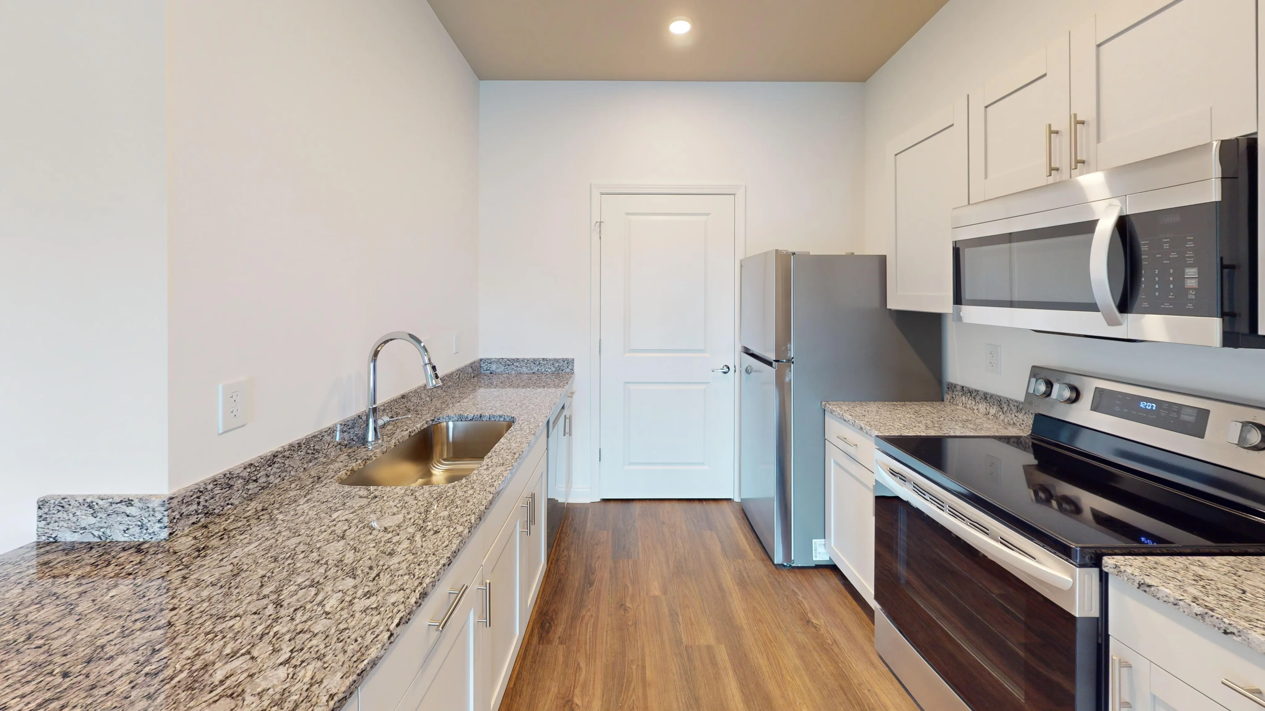Bright and airy modern kitchen featuring stainless steel appliances.