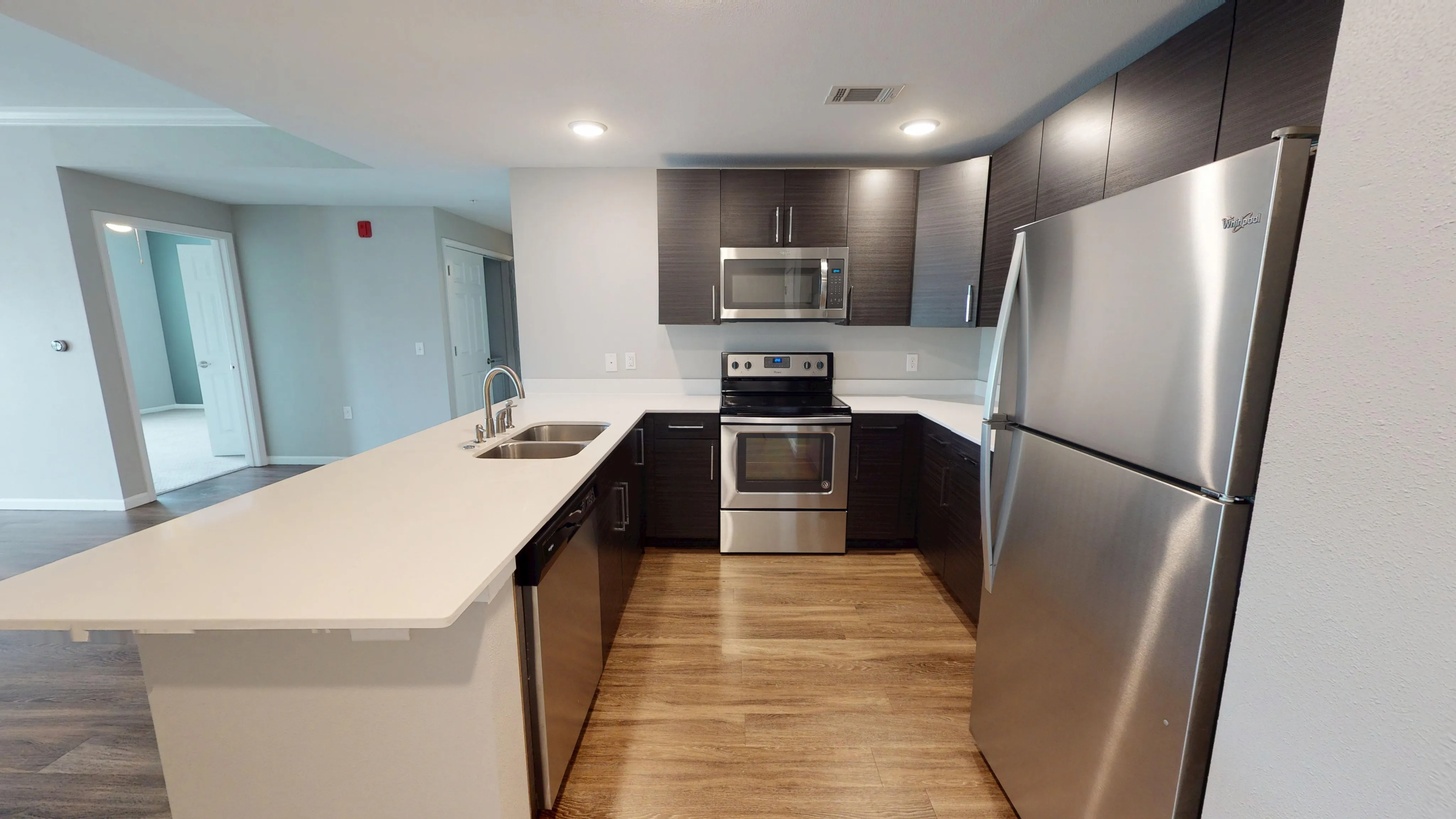 Modern kitchen with sleek dark cabinetry, stainless steel appliances, and an inviting open layout perfect for entertaining.