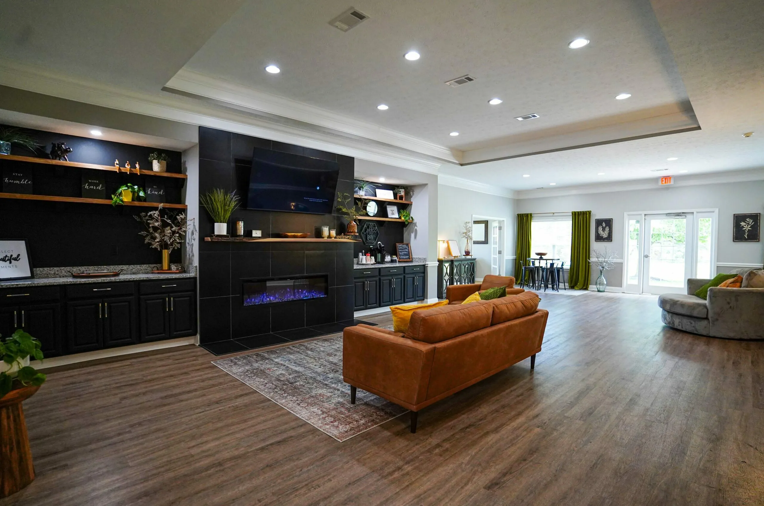 Luxurious living room boasting a modern fireplace, stylish built-in shelving, and elegant seating area with natural lighting from large windows.