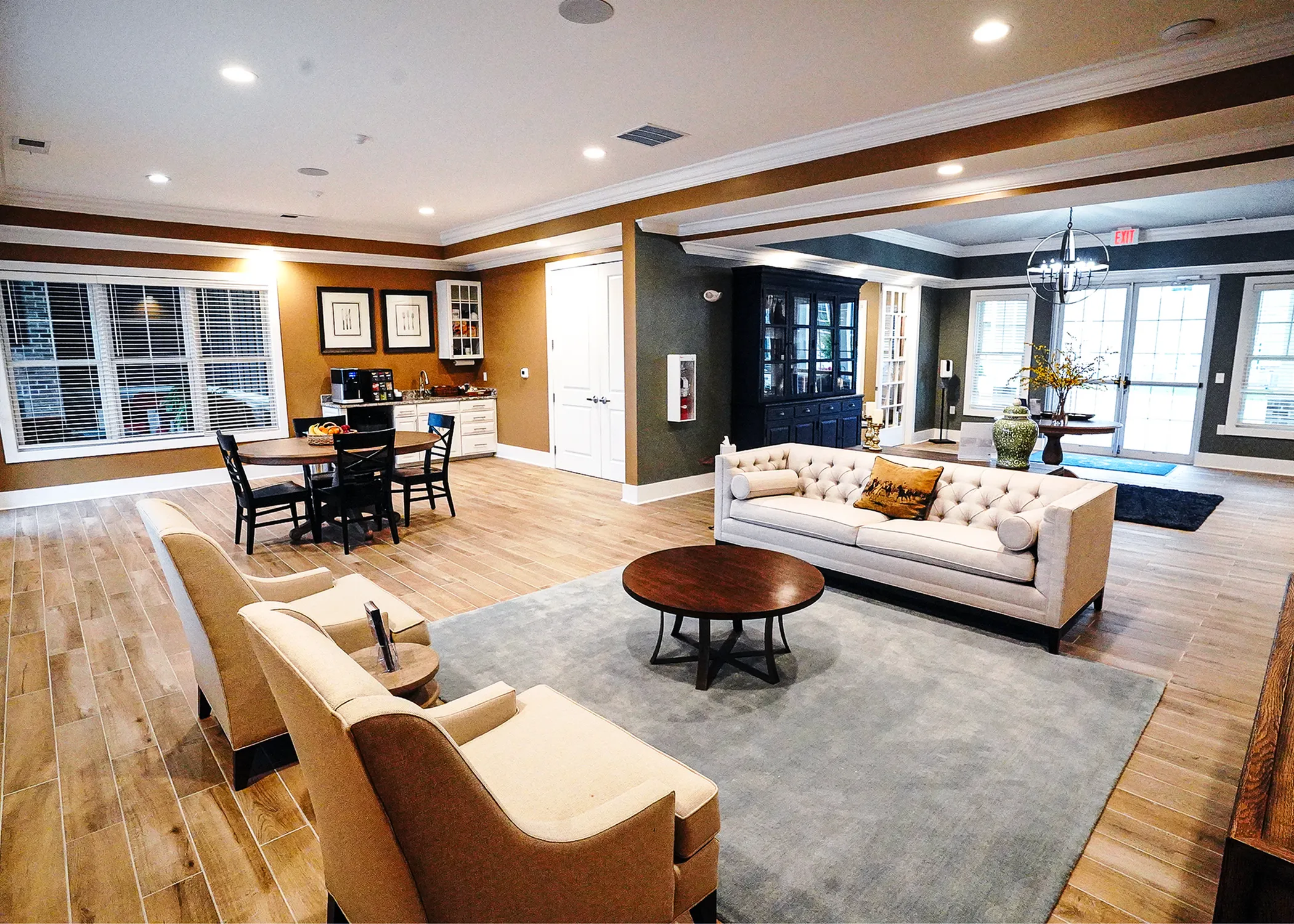 Interior of The Ventry clubhouse featuring a cozy resident lounge, dining tables, and a modern coffee bar.