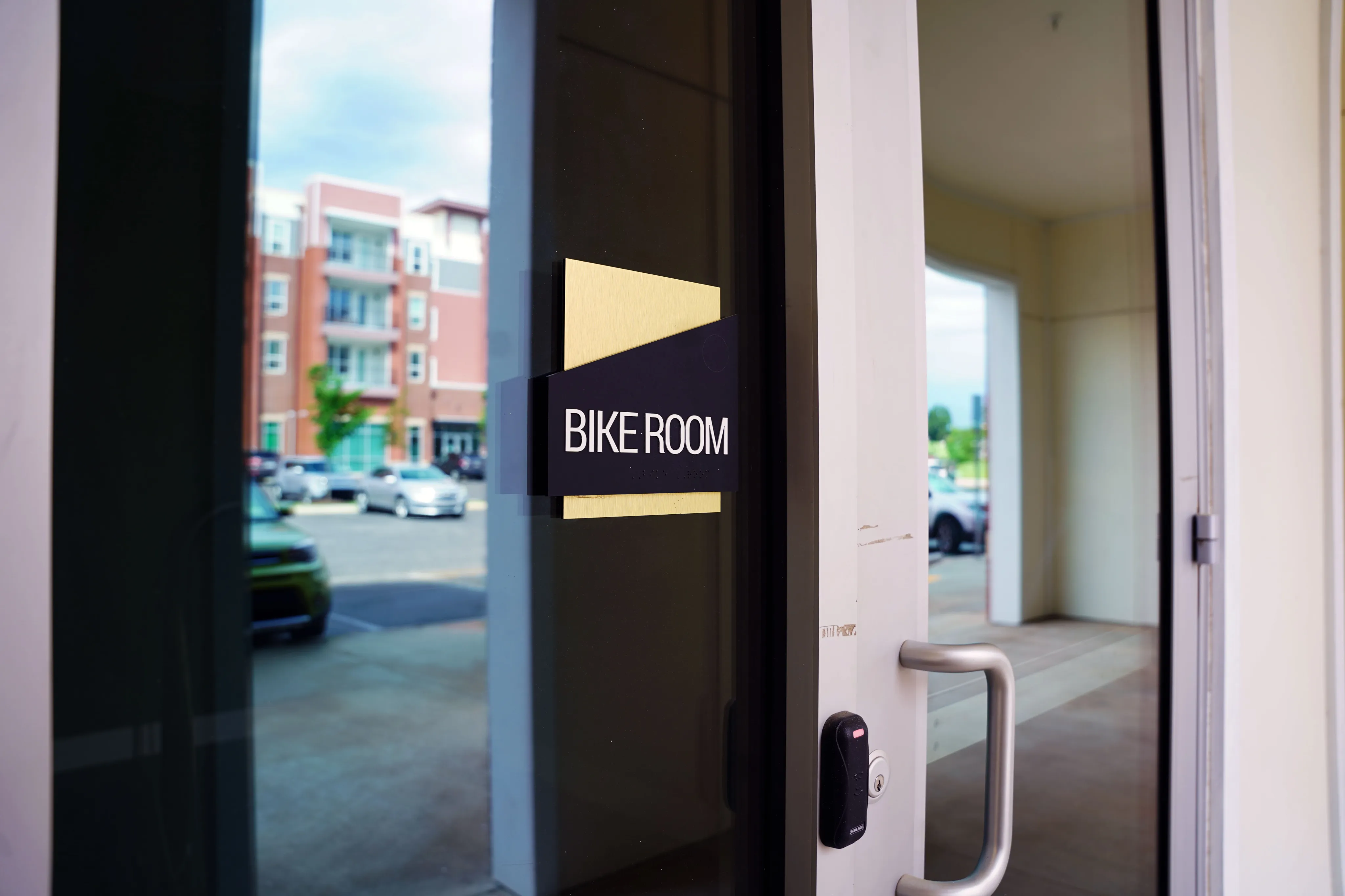 Contemporary bike room entrance in a modern apartment complex with secure access.