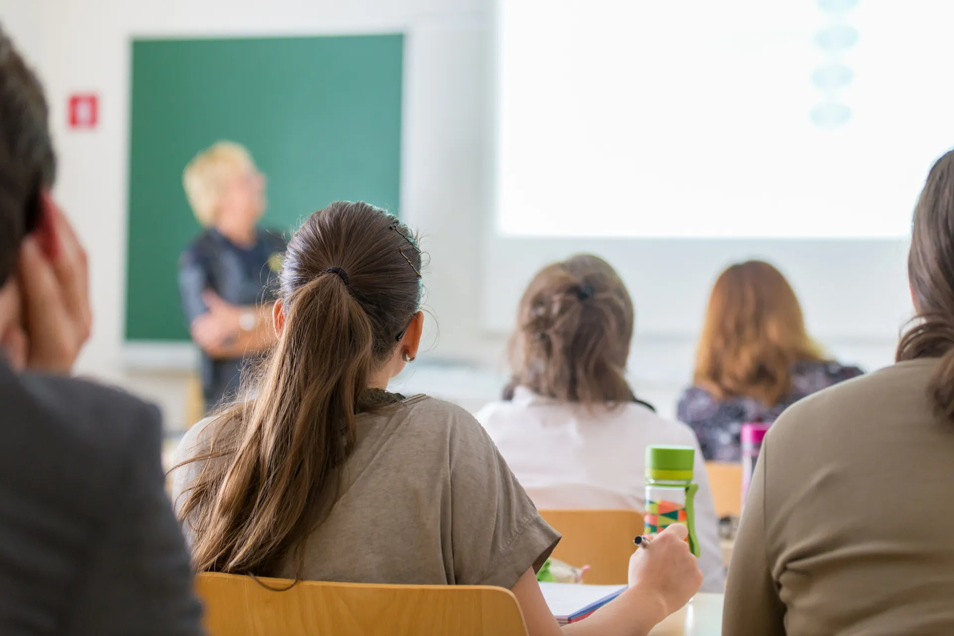 Engaged students attentively participating in a bright, modern classroom setting, highlighting a vibrant educational environment.