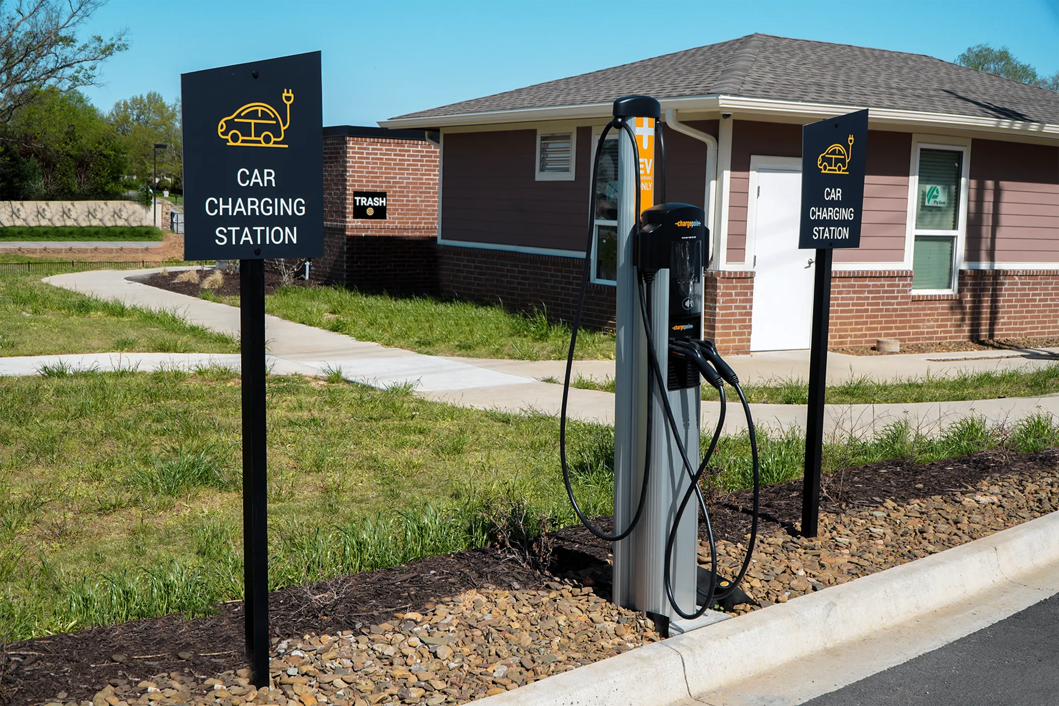 Modern car charging station outside residential area with eco-friendly amenities and convenient access.