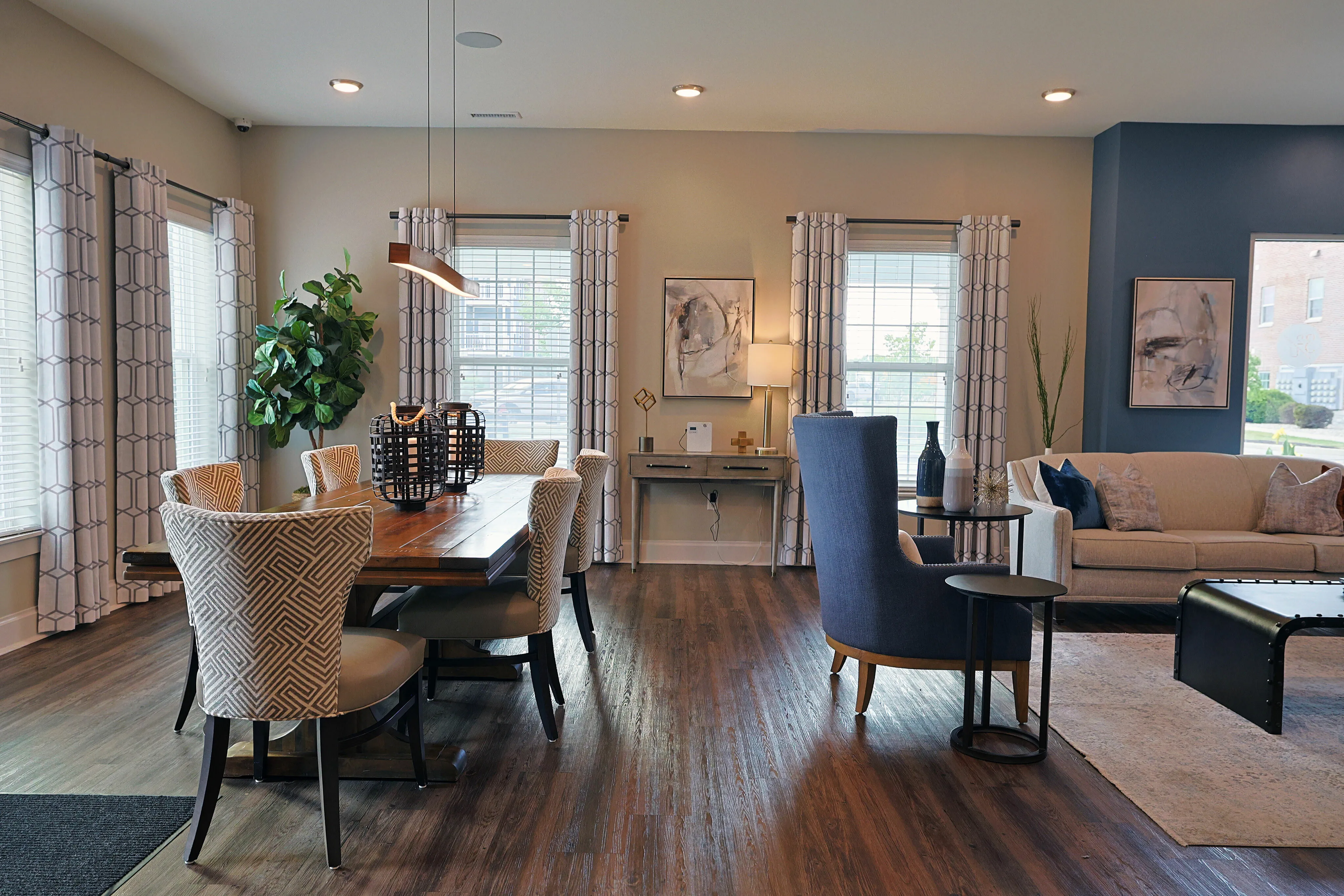 Inviting open-concept living and dining area with elegant decor, featuring a cozy seating arrangement, modern dining table, and abundant natural light.