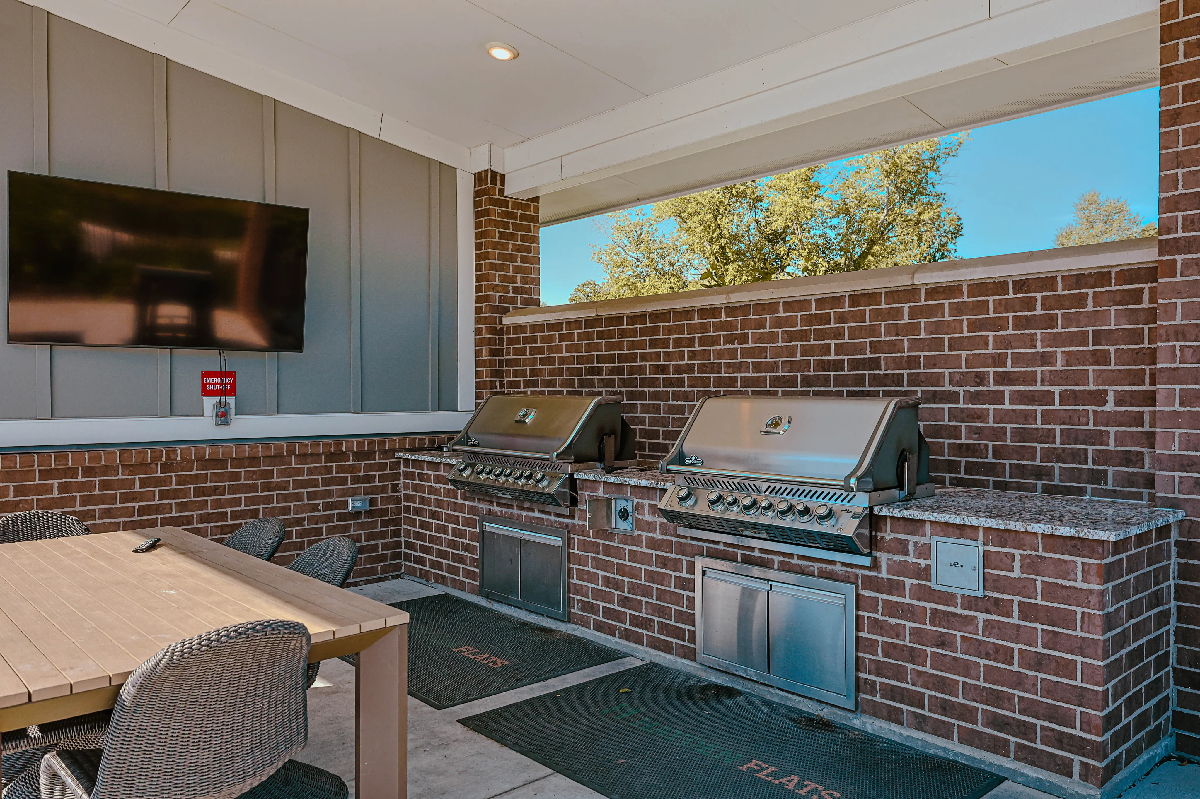 Inviting outdoor barbecue area with modern grills and comfortable seating, ideal for entertaining and enjoying al fresco dining.