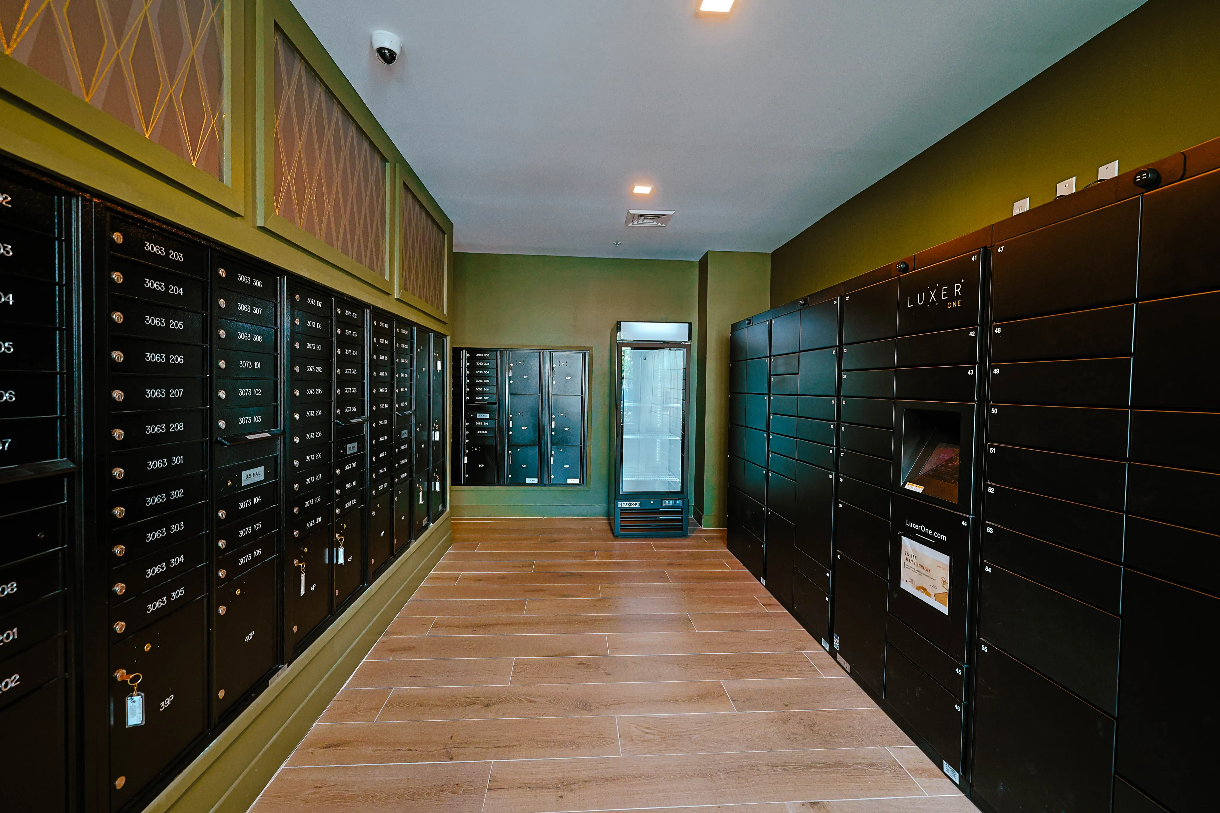 Modern parcel locker room with sleek black lockers and warm wood flooring, offering secure and convenient package pick-up.