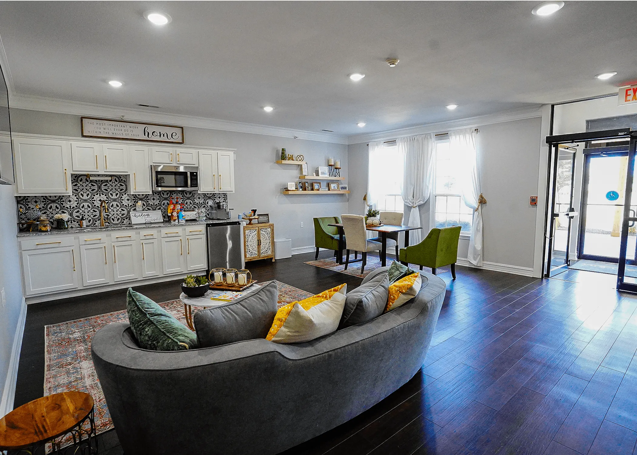 Modern open-concept living space featuring a chic kitchen with patterned backsplash, cozy seating area, and a stylish dining nook with natural light.