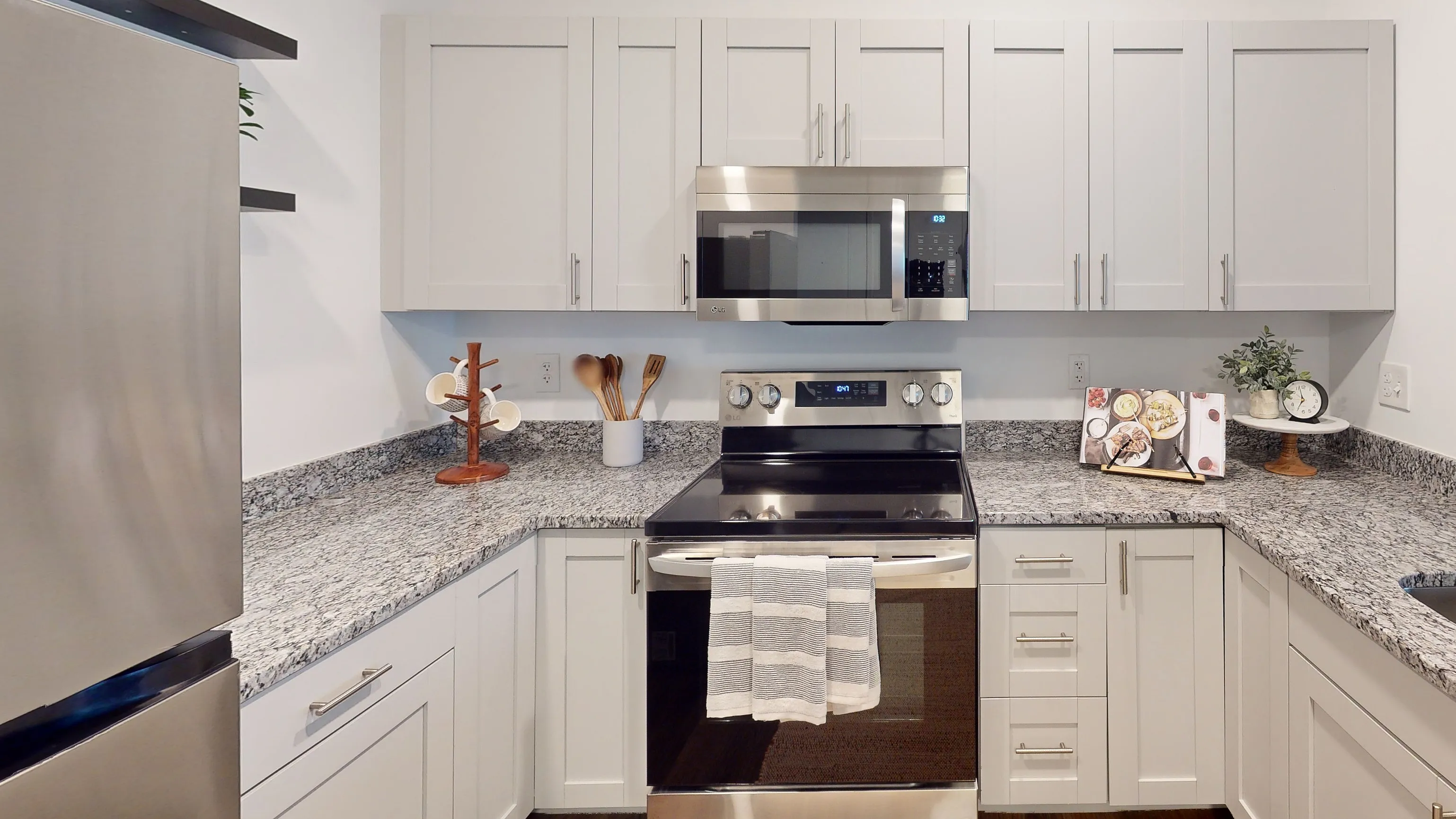 Modern kitchen with sleek stainless steel appliances, elegant granite countertops, and ample cabinet space, perfect for culinary enthusiasts.