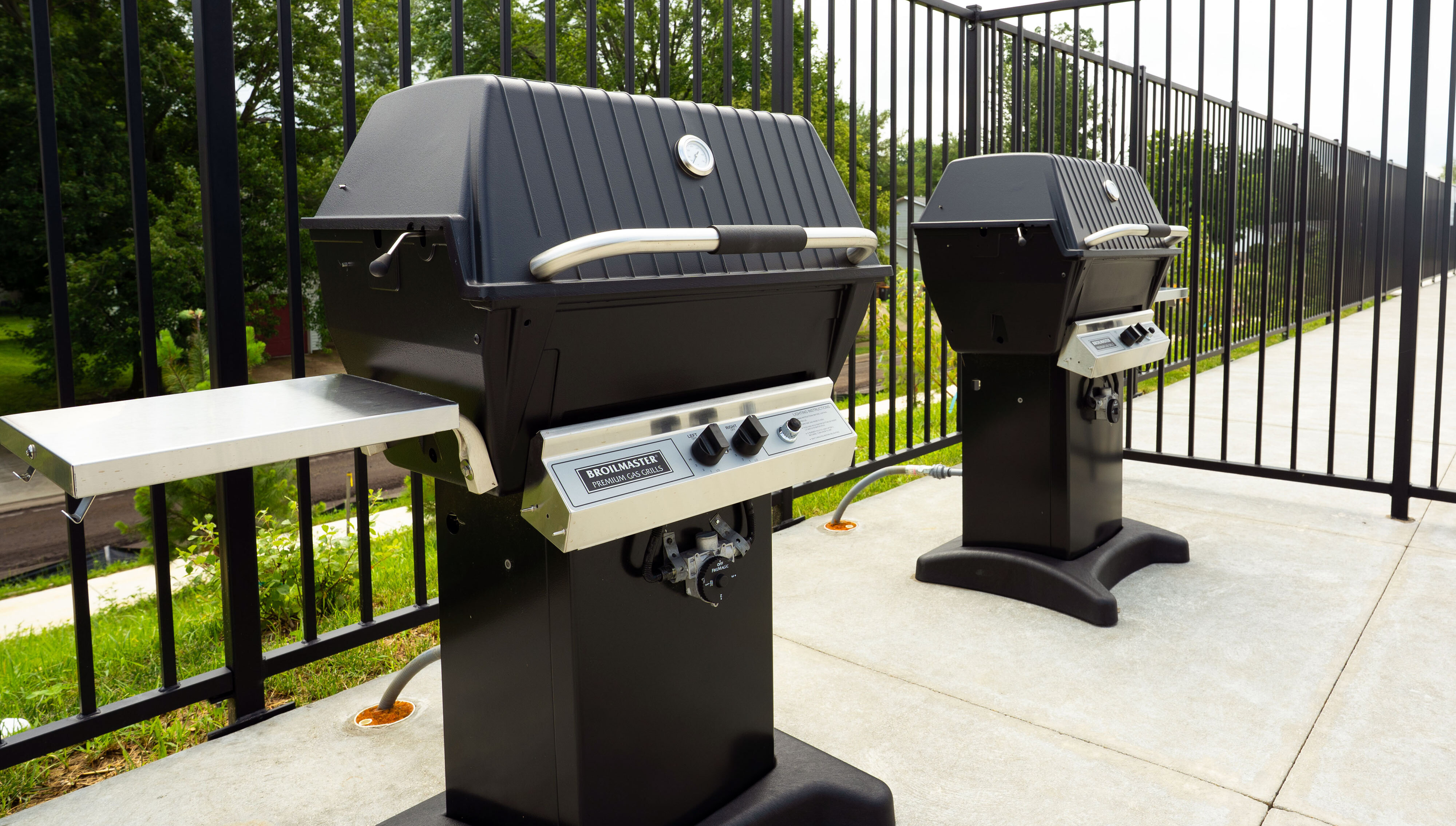 Inviting outdoor patio featuring two high-end grills, perfect for summer barbecues and gatherings.