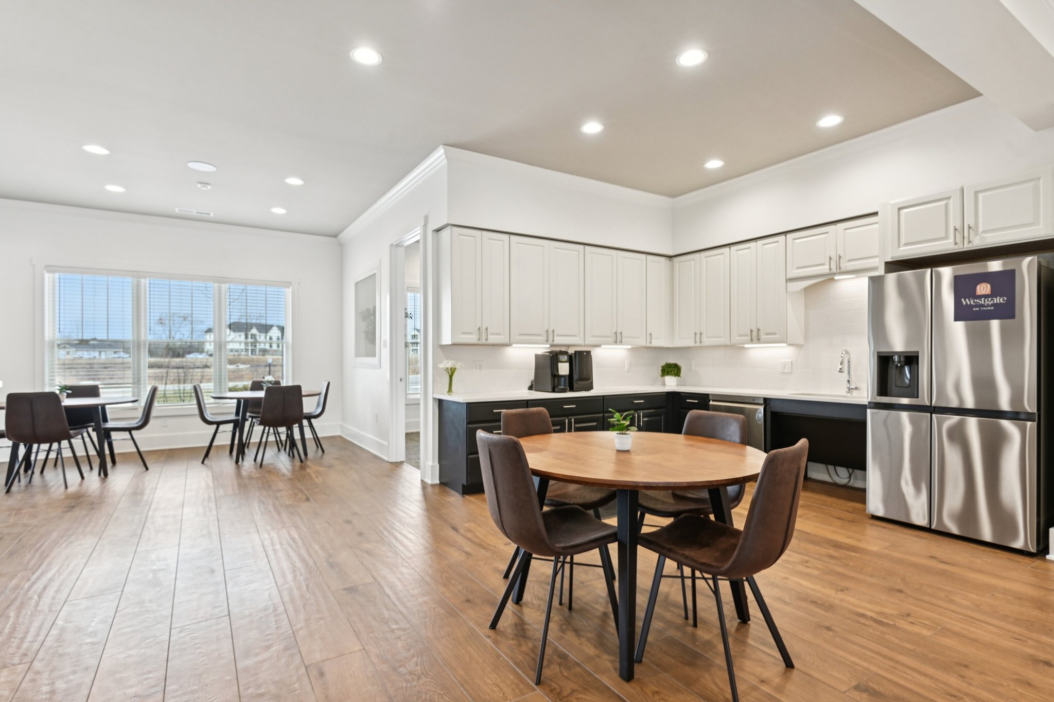 Bright and modern kitchen area with sleek cabinetry, stainless steel appliances, and elegant dining spaces, perfect for gatherings.