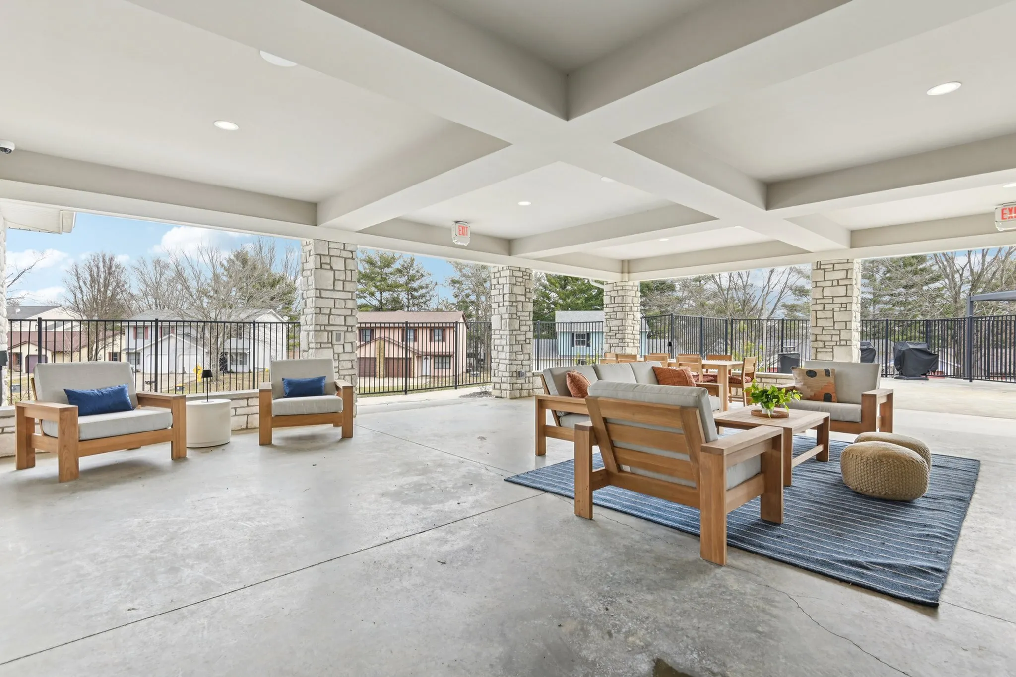 Inviting outdoor lounge area with stylish wooden furniture and cozy cushions, perfect for relaxation and social gatherings.