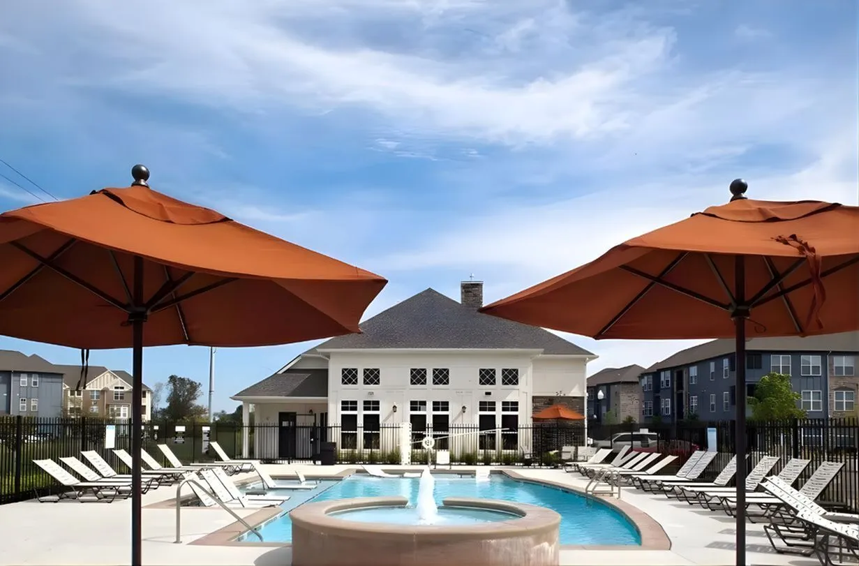 Inviting outdoor swimming pool area with stylish loungers and elegant gazebo under clear blue skies.
